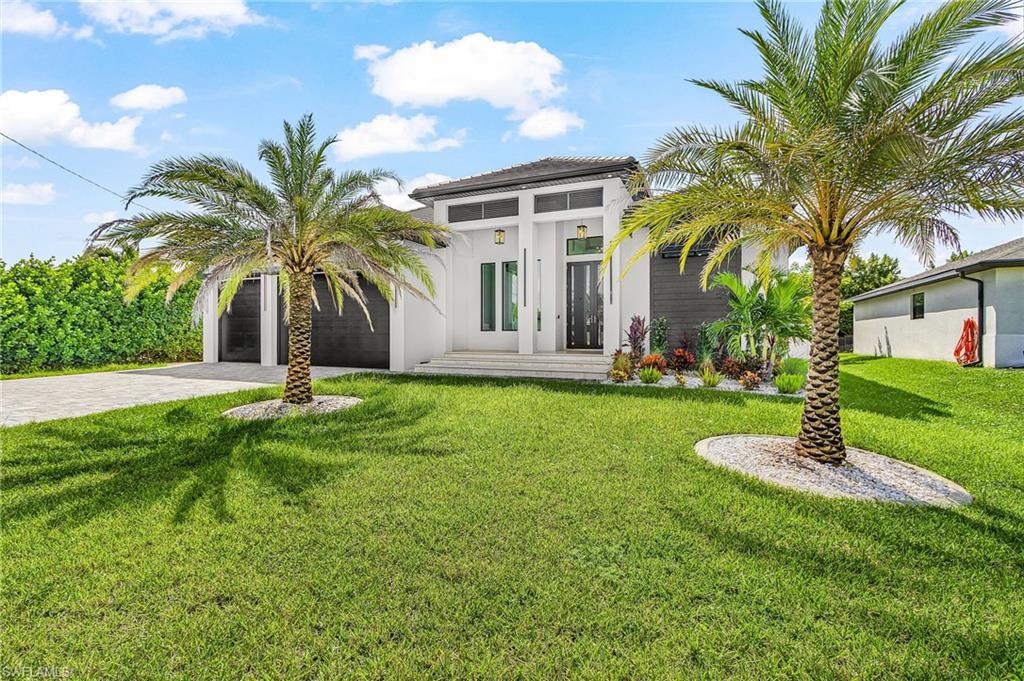 Welcome to this spectacular, stunning home with modern flair in one of Cape Coral's most sought-after neighborhoods!! PRIME SOUTHERN REAR EXPOSURE! LUXURIOUS FINISHES & FEATURES THRU-OUT!!This elegant residence offers 4 bedrooms + den, 3 full bathrooms, a spacious 3-car garage, and a resort style heated salt water pool & spa.  The open-concept floor plan seamlessly connects the living, den, dining and kitchen areas.  As you step inside, you will be greeted by a stunning custom fireplace wall, tray ceiling, & zero corner sliding glass doors that open up to your private tropical oasis, merging your indoor & outdoor living and expansive entertainment space.  The kitchen is a true centerpiece, showcasing beautifully designed two-tone flat panel cabinetry, waterfall quartz island, KitchenAid appliances, built-in wall oven/microwave, Pot filler, full quartz backsplash, pendant lighting, built in lighted glass display with wine cooler/beverage fridge & Fisher and Paykel coffee machine. The primary suite offers a serene retreat with two walk in closets, spa-style bathroom: separate vanities, walk in duel shower & stand alone tub. Two nicely appointed guest bedrooms and bathroom are located near the kitchen & dining area, while the 3rd guest bedroom doubles as a secondary suite at the back of home with its own dry bar and dedicated bathroom with access to pool area. Step outside to your resort-style outdoor living area complete with heated salt water pool & spa, outdoor kitchen with gas cooktop, sink, beverage fridge & modern herringbone backsplash, island, wood ceiling accents, outdoor shower, screened pool cage, enhanced lush areca palms & privacy fence to create your own secluded oasis. Spacious inside laundry room with full size Electrolux stackable washer/dry, cabinetry and sink. The garage features epoxy floors, while the paved driveway adds to the home's impressive curb appeal.   Impact Windows & Doors, Tile Roof,  High Ceilings, Lutron Lighting Control System, Upgraded Hunter Douglas Window Coverings w/ Powerview Pirouettes In Dining & Living, Automated Heated Pool & Spa, Outfitted Closets, Plank Tile, Accent Tiles, Lighted Bathroom Mirrors, Ceiling Fans, & more!! THIS HOME HAS IT ALL!! Just minutes from Joe Stonis Park, Sirenia Vista Park, Burnt Store Marina, boat ramps, shopping, dining and more! SCHEDULE YOUR PRIVATE SHOWING TODAY!!