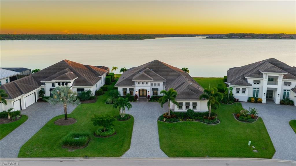 BEST VIEW IN WILDBLUE! 1 Mile Long, 1 Mile Wide, Southern Exposure Lake View! 13119 Cerulean Ct is a masterful Estate home on a premium southern exposure lake view lot, built by the renowned Stock Development and offered fully furnished. Homes are rarely available on this street, which consists of just 11 custom built homes, no traffic, stunning southern-facing lake views with preserve on the other side, and no homes across the street. This coveted Sterling model offers open concept living, four private ensuite bedrooms plus a den, a luxurious master retreat, and a massive outdoor living area spanning the entire width of the home. Custom accents, trim work, and upgrades have been added to every part of the home, creating an inviting and refined atmosphere. The kitchen features upgraded two-tone cabinetry, custom quartz countertops, designer backsplash, built-in appliances with a gas cooktop, a spacious walk-in pantry, and a hidden prep pantry with a beverage center. The spectacular master suite includes dual walk-in closets, a large bathroom with dual vanities and a separate shower and tub, and French doors from the bedroom leading to the covered lanai. The upgraded travertine pool deck stretches the full width of the home and around the back of the pool, providing plenty of space for both covered and uncovered furnishings without compromising walkability. The custom heated pool features a 360 degree spillover spa and added waterfall bowl features to create a serene atmosphere overlooking the mile-long lake view. For peace of mind during storms, the home is equipped with impact windows and doors, a whole-home generator, automatic hurricane rolldown screens on the back lanai, and among the lowest risk flood zones in all of Southwest Florida. This lot allows for a private dock to be built with an optional boat lift. WildBlue's amenity peninsula provides panoramic views of WildBlue Lake and features a resort-style pool, separate lap pool, sandy lakeside beach, fitness center with studios, locker rooms with saunas, spa, a full-service restaurant and bar, poolside bar and grill, tennis and pickleball courts, a pro shop, basketball, boat ramps to over 800 acres of freshwater lakes, boat slip rentals, kayak storage, and more. Schedule your private showing today!