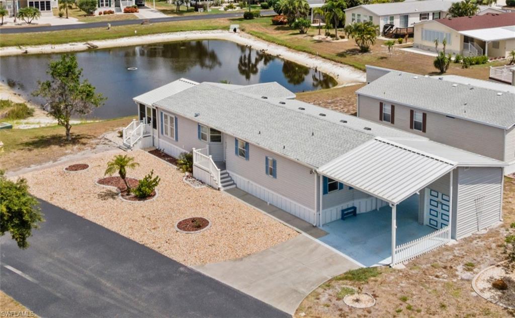 Space, style, and serene water views come together in this exceptional manufactured home in The Pines at Sandalhaven. Perfectly positioned on a desirable corner lot overlooking the tranquil pond, this spacious residence is one of the community's LARGEST FLOOR PLANS and is loaded with standout features, including a NEWER ROOF (2024), a DEDICATED GOLF CART GARAGE, EXTRA STORAGE, and BEAUTIFUL ARCHITECTURAL DETAILS throughout. From the moment you step inside, soaring cathedral and tray ceilings, elegant arched windows, and an abundance of natural light create a bright, open atmosphere that instantly feels warm and inviting.***
Designed with both everyday comfort and entertaining in mind, the expansive living room flows seamlessly into the generously sized kitchen, where a large center island, new appliances, extensive cabinetry, and ample counter space provide the perfect setting for everything from casual mornings to holiday gatherings. A true utility room, featuring a TANKLESS WATER HEATER, keeps daily tasks neatly tucked away?. The MASSIVE PRIMARY SUITE offers a peaceful retreat complete with an oversized walk-in closet and a spa-inspired ensuite bathroom featuring dual vanities, a relaxing garden tub, and a separate step-in shower. Maximize both indoor and outdoor living with an enclosed sunroom and your very own deck for the perfect spots to enjoy the Florida sunshine. Every detail in this home has been thoughtfully designed to maximize space, functionality, and comfort.~~~
Located within the welcoming 55+ community of The Pines at Sandalhaven, you'll enjoy the perfect blend of relaxation, recreation, and the carefree Florida lifestyle you've been dreaming of. Residents have access to a sparkling community pool, shuffleboard courts, a vibrant clubhouse, and a full calendar of social activities and events. Just across the street, the Wildflower Preserve offers peaceful natural beauty, while the pristine beaches of Boca Grande are only a short drive away for shelling, boating, fishing, and breathtaking Gulf Coast sunsets. Whether you're looking to stay active, connect with neighbors, or simply enjoy the sunshine year-round, this exceptional home offers it all. Schedule your private showing today!