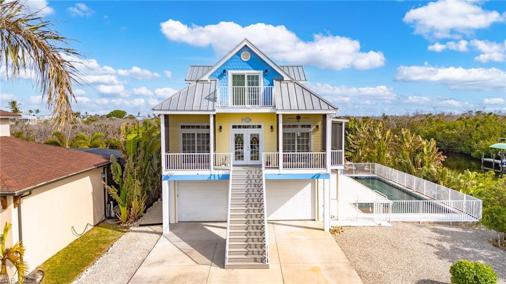 As you enter this unique custom home you will be surrounded by tropical colors accented with the warm tones of bamboo, cypress, and mahogany.  The architecture and decor were inspired by the current owners' travels to the Keys, Caribbean, and South Pacific.  The floor plan was designed with the retired couple in mind, anticipating many visits from adult children and grandchildren.  The master suite is located on the main floor, while the third floor has three bedrooms and its own bathroom, thus giving privacy to all when wanted.  

This is a very comfortable home for day-to-day living.  With its many windows and screened porches, this home is bright and airy, often times does not need AC due to the flow-through breezes.  There is even a small screened porch directly off the kitchen that was designed just for the grill, and also a breakfast porch.  The floor treatments are a combination of tile, carpet, and wood for easy maintenance and sound control.  Just inside the front door is a room that was designed as an office with double entry doors, perfect for a business in the home.  There is a conveniently located elevator that goes to all three floors.  On the main floor the elevator stop is in the kitchen, making bringing up groceries from the garage to the kitchen a breeze.

The ground level offers a large garage and an air conditioned bonus room with an attached bath and outdoor shower.  The garage ceiling height is 10 foot, with 9 foot garage doors, including plenty of room for vehicles and storage.  

Outside you will find nearly one-half acre of land with approximately 360 feet of waterfront, with mere minutes to San Carlos Bay, the Intracoastal Waterway, the Gulf of Mexico, and all the outer islands of Lee County, including some of the best fishing in all of SW Florida!  The environmentally friendly landscape includes many palms, bamboo, bougainvillea, hibiscus, orange tree, oleander, and even a gumbo limbo tree.  The shoreline is lined with sea grapes and mangroves, true Florida native plants.  As you step down onto the approximately 100 feet of dock you will find a 20,000 pound and a 7,000 pound boat lift along with a covered fish cleaning station.  From the main floor of the home, you will enjoy descending the spiral staircase onto the pool deck of the 50 foot by 10 foot lap pool.  The pool also has an adjacent shallow area especially for the toddler grandchildren.  On those hot Florida days, you will enjoy the shade of the pool deck's tiki and using the wonderful outside tiki shower.  As an added feature all outside deck railings are constructed of low maintenance aluminum, and decks and docks are composite planked.

While not included in the price, some furnishing and the 21 foot Key West boat are negotiable.