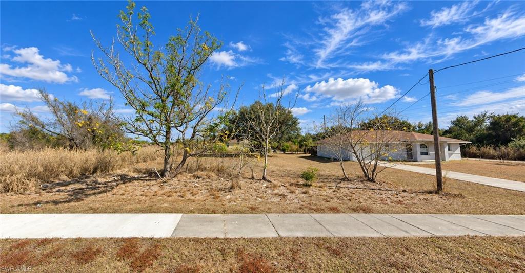 Land in Lee County for $16,000, on a street where the homes are already built. This 0.14-acre residential lot (approx. 50 x 125) sits on paved, county-maintained First Street in the Charleston Park community of Alva, just south of SR 80 (Palm Beach Blvd). You get the quiet, open feel of rural East Lee County with a straight run west to Fort Myers and I-75.

Your front yard looks west across open farmland. That means sunsets over the fields and no rooftops staring back at you. A sidewalk already runs along the frontage, and the Charleston Park lighting district keeps the street lit at night. Curbside garbage and recycling pickup comes every Friday. Neighboring lots have homes on them, so you are building into an established street instead of waiting years for a subdivision to fill in.

Carrying costs are about as low as it gets. The 2025 tax bill was $113.96, with no HOA and no mandatory fees. Hold it while you save, or break ground when you're ready.

Much of the early homework is done. A boundary survey has been completed by Nexgen Land Solutions. Per the seller's disclosure, there are no known wetlands or environmental issues on the lot. The seller also reports no encroachments or code violations.

Zoned RS-1 for single-family residential on a platted lot. Owner-builders get a homesite without a big lot payment. A small builder gets an infill spec site where homes already stand. Investors get Lee County land that costs almost nothing to hold. Cash and conventional offers are welcome.

Charleston Park, the county park just up the road, has covered basketball courts and a picnic pavilion. Alva's stretch of the Caloosahatchee River is a short drive for fishing and boating, and LaBelle is easy to reach to the east.

Buyer due diligence: The lot is in FEMA Flood Zone AE (Panel 12071C0329G, effective 11/17/2022), so plan on elevated construction to avoid flood insurance. There is no public water or sewer at the site; a well and septic system will be needed. Lot dimensions come from a previous appraisal and Lee County Property Appraiser records. Buyer to verify zoning and permitting requirements with Lee County Community Development.

Walk it, bring your builder, and make your plan.