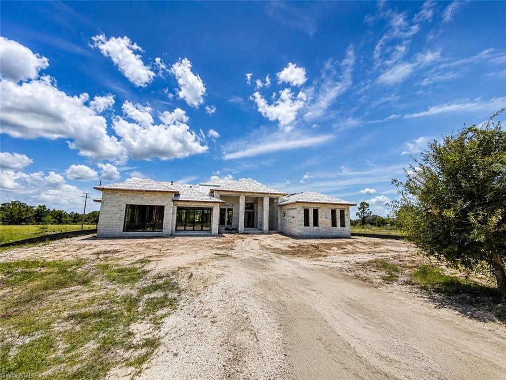 List price is starting price. Brand new luxury custom estate on 2.5 acres  scheduled for completion before closing! Offering 3,169 square feet under air, nearly 5,000 total square feet, and an oversized 4 car garage, this exceptional home combines timeless design, premium craftsmanship, and modern convenience in a private estate setting.
From the moment you arrive, you’ll appreciate the elegant paver driveway, durable concrete tile roof, hurricane impact windows and doors, upgraded insulation, and impressive 15 foot ceilings with tray ceiling details that create an open, airy feel throughout.

The chef’s kitchen is designed to impress with custom cabinetry, waterfall edge countertops, a full height backsplash, a natural gas cooktop, and a spacious walk-in pantry. An oversized laundry room with custom cabinetry provides abundant storage and functionality.

Every bedroom is a private retreat, featuring a walk in closet and its own en-suite bathroom with custom tile finishes and frameless glass walk-in showers. The luxurious owner’s suite offers a spa inspired bath complete with a soaking tub.

Designed for seamless indoor-outdoor living, the expansive covered lanai overlooks a custom pool surrounded by pavers and enclosed by a large picture-window screen enclosure, maximizing unobstructed views of your private acreage. A versatile flex room with direct access to the pool includes a full bathroom, making it ideal for multigenerational living, a private guest suite, home office, or pool cabana.

Additional premium features include an underground 500 gallon propane tank, natural gas cooktop, gas dryer hookup, gas tankless water heater, natural gas pool heater, and a whole-home standby generator capable of powering the entire residence during extended power outages.

Scheduled for completion prior to closing, this is a rare opportunity to own a one of a kind custom built estate where luxury, functionality, and quality craftsmanship come together on 2.5 private acres.