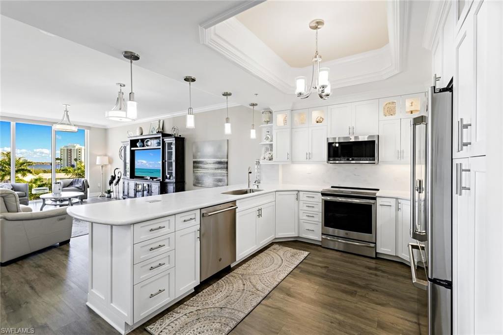 Step into luxury at this beautifully renovated, one-of-a-kind condo in the prestigious North Star Yacht Club. Floor-to-ceiling windows showcase breathtaking views of the marina, river, and pool, creating a stunning backdrop for everyday living. The thoughtfully redesigned kitchen features custom cabinetry, designer lighting, an expanded footprint, enlarged countertops for added workspace, and an elegant tray ceiling. Innovative conveniences, including pop-up electrical outlets and a refrigerator with built-in coffee-making capabilities, add a modern touch.
The versatile den/guest bedroom offers exceptional functionality with custom built-ins, a wireless in-counter phone charger, and a Murphy bed, seamlessly blending style and practicality. Enjoy an impressive 15,000 square feet of amenities, including a clubhouse, theater, aerobics studio, fitness center, steam rooms, locker rooms, heated pool, and spa, all set across 12.5 lush waterfront acres. For boating enthusiasts, marina slips are available to lease. Stroll along the marina to four waterfront restaurants, or hop aboard the complimentary seasonal trolley to explore the revitalized Downtown Fort Myers River District, featuring more than 60 restaurants, shops, galleries, theaters, and other attractions. Experience the perfect blend of luxury, convenience, waterfront living, and an exceptional lifestyle at North Star Yacht Club.