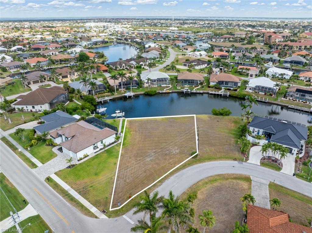 Your next home begins with one decision: where will you keep the boat?
This oversized 11,611 square foot sailboat-access homesite is located on a quiet cul-de-sac canal in Punta Gorda Isles, one of Southwest Florida's most established waterfront communities. Featuring 60 feet of city-owned and maintained concrete seawall, this property offers a valuable benefit rarely found in waterfront communities.
Launch from your future dock and follow the protected no-wake canals approximately three miles to Buckley's Pass. From there, enjoy unrestricted boating on Alligator Creek, Charlotte Harbor, and the Gulf of Mexico. Whether your passion is fishing, boating, waterfront dining, or simply spending time on the water, this location makes it easy to enjoy the Florida lifestyle year-round.
The oversized lot provides flexibility for designing a custom home with generous outdoor living areas and a pool. Public water, sewer, electric, and fiber are available at the road. Surrounded by newer custom homes, the neighborhood offers a peaceful waterfront setting while remaining just minutes from nearby fuel docks, Fishermen's Village, historic downtown Punta Gorda, Punta Gorda Airport, and I-75.
No HOA. No CDD fees. Punta Gorda Isles is now more than 90% built out, making quality waterfront homesites increasingly difficult to find. Whether you're building now, planning for retirement, or investing for the future, this property offers an outstanding opportunity to own a piece of Florida's boating lifestyle.