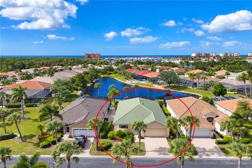 Virtually Staged. A wonderful opportunity awaits in this bright & cheery lakefront pool home in Courtside Landings, one of Burnt Store Marina’s most sought-after neighborhoods. Courtside is situated in the heart of the gated community of Burnt Store Marina and is steps away from the fitness center, which boasts a vibrant tennis and pickleball scene. You are also steps from SW Florida's  largest deep-water marina (home of Freedom Boat Club), and a short  bike or golf cart ride to waterfront dining and the golf course. This waterfront charmer is framed by lush palms and a tropical landscape, and boasts a covered front porch with white rails to welcome you home.  From the moment the front door opens, you will be drawn inside by the fabulous open plan with pleasing views of the sparkling pool and lake beyond. This expanded Everett floorplan features a wonderful disappearing wall of sliding glass doors that not only flood the space with natural light but seamlessly connect the indoor and outdoor living spaces. Volume ceilings are complimented by neutral tones and tile floors through the main living area. The bright and practical open kitchen dons crisp white raised panel cabinetry with generous solid surface counter tops, an inviting breakfast bar, pantry closet and a sunny dining nook with sliding doors to the side courtyard. The cook will truly feel like they died and went to heaven when whipping up their favorite meal while enjoying tropical breezes and cheery Florida sunshine. You are sure to exhale when you enter the spacious primary suite, which boasts picturesque lake views. The  en-suite bath is bathed in natural light and offers a vanity with dual sinks, soaking tub, separate stall shower and private commode. A linen closet and walk-in closet provide ample storage.  On the other side of  the home, an inviting guest bedroom and guest bath enjoy privacy, while in between is a flex room that works well as a den, home office, hobby room or extra sleeping space. Outdoors is where this home shines. The dramatic picture window screen enclosure beautifully showcases the scenic lake that is home to Florida wildlife. The sparkling pool with a swim up table will no doubt be your favorite spot to indulge yourself in the afternoons. The ample covered seating area will be a great place to catch up with friends or lounge with a great book.  Whether it’s morning coffee, an afternoon swim or a sunset over the lake, this is Southwest Florida living at its best. An attached two-car garage has room for two vehicles, or a golf cart and storage. Finishing off the space, a separate utility room with extra cabinets adds everyday convenience. When not enjoying your piece of paradise, it’s an easy drive to downtown Punta Gorda, Cape Coral and Punta Gorda Airport.