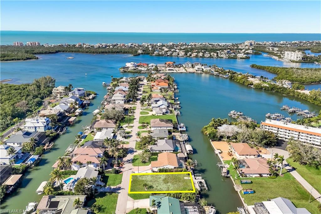 One or more photo(s) has been virtually staged, AI generated or rendered.  One or more photo(s) has been virtually staged, AI generated or rendered.
Exceptional Gulf-access waterfront homesite offering approximately 0.21 acres in a desirable Bonita Springs boating community. The property includes custom luxury home plans designed by NorthStar Technologies, providing inspiration and a head start for a future waterfront residence. 

The proposed three-story design features approximately 3,173 Square feet of air-conditioned living space, expansive outdoor living areas, a private pool, rooftop deck, elevator and multiple garages.

Existing improvements include a wraparound dock built in 2015, a 10,000 pound boat lift and a 7,000 pound submersible lift suitable for kayaks, jet skis or other personal watercraft. Enjoy convenient Gulf access and location approximately 1.5 miles from Bonita Beach and Barefoot Beach.

Situated on a quiet dead-end street near waterfront restaurants, shopping, dining, grocery stores, fitness centers, Mercato and Coconut Point. This property offers an opportunity to create a custom primary residence, seasonal retreat or investment property in a sought-after coastal location. Home plans and builder information are available upon request.