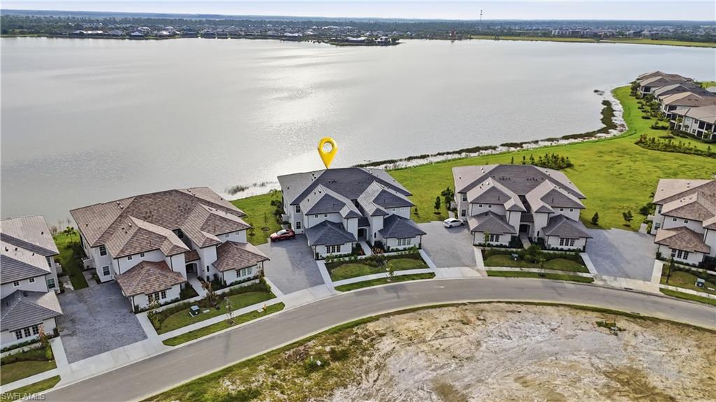 Lake Views. Turn-KEY furnished. Just bring your suitcase everything else is ready GOLF CART INCLUDED. 2376 sq ft second floor with elevator privacy unmated 180 degree lake views. This brand new barley lived in Willowgreen coach home in Babcock Ranch is offered fully furnished and move-in ready, golf cart included. Nearly new furnishings, kitchenware, and linens all convey, so you can start living the Babcock lifestyle the day you close. This upstairs residence offers 3 bedrooms plus a den, 2 full baths, and a split bedroom plan that gives guests their own private wing. The den is perfect for a home office, hobby room, or overflow guest space. A PRIVATE residential elevator makes coming and going easy and adds long-term livability. Generous closets throughout and a bright, open living area ready for entertaining. Hop in the golf cart and explore the trails, community pools, Lake Babcock, and the shops and dining of Founder's Square in America's first solar-powered town. Skip the build wait, the furniture shopping, and the delivery dates. Everything is here and ready for you. Perfect for seasonal residents, second-home buyers, and anyone ready to simplify.
