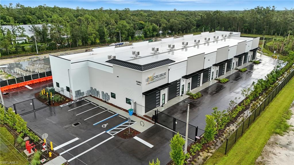 Welcome to Excalibur Motor Condominiums, where value meets security and luxury. Unlike typical ‘storage facilities’ in SWFL, Excalibur offers unmatched standard features—all at a more accessible price point—making it one of the safest and most sought-after options in the region. 13461 Shire Ln, Unit #120, Fort Myers, FL 33912 is one of our well-appointed standard units, offering 1,350 total square feet. This includes a 25x40 ft ground floor and an additional 320 sq ft mezzanine. Whether you're envisioning a sleek home office, a laid-back Man Cave, or a stylish She-Shed, the mezzanine provides the perfect elevated retreat. Constructed from 100% concrete and rated to withstand 170+ MPH winds, Excalibur stands strong in any weather. Built 20 ft above sea level in FEMA Zone X, your investments remain protected, even during major storm events like Hurricane Ian or Milton. Security is a top priority, with features that include an 8 ft perimeter fence, dual gated entry points with cameras, motion-activated security lighting, and 24/7 video surveillance throughout the development. Each unit is packed with premium features: Individual climate control systems securely mounted on the roof Private full bathroom with a shower 220V / 200 AMP electrical service Custom 16’ x 14’ insulated garage door Impact-rated glass entry door for added light and style All units are also addressable for mail and parcel delivery, enabling practical use as a workspace. Plus, you’ll enjoy high-speed internet, second-floor plumbing and drainage to easily add a wet bar or kitchenette, and energy-efficient TPO roofing designed for long-term performance. In our Second Phase, we offer an array of expanded layouts: The 1.33 Unit at 1,800 SF The 53-Footer at 1,695 SF, with a 53’ long first floor ideal for RVs The unique L-Shape Unit, nearly 2,000 SF with dual garage doors The spacious Double Unit boasting 2,700 SF of total space Looking for something tailored? The developer welcomes customizations during construction, helping you craft a unit that fits your vision and lifestyle. At Excalibur, every unit is delivered with our full suite of premium amenities. This is more than storage—this is peace of mind, elevated design, and enduring protection for your luxury assets.