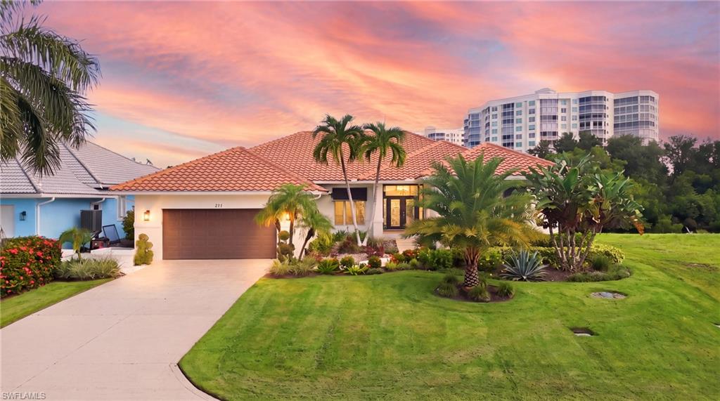 211 Flamingo Ave offers a substantial waterfront residence with an exceptionally spacious and functional floor plan, extensive recent upgrades and remodeling, and an outstanding location in the heart of Vanderbilt Beach. Set on an 80 by 121 foot Gulf access lot, the property is uniquely positioned with no homes directly across the canal, creating added privacy and a peaceful waterfront setting, along with some of the quickest Gulf access in Conners Vanderbilt Beach Estates. The home features 2,732 square feet of living area with four bedrooms, including one ideally suited as a private office or den with direct access from the primary suite, multiple living spaces, a pool and spa, and an oversized two car garage. The interior is open and bright, with a formal dining area, secondary family room, eight foot sliders and distinctive corner mitered windows. The updated kitchen features Bosch appliances, extensive cabinetry and storage, pantry space, and a built in wet bar with beverage cooler. A brand new additional freezer and ice maker have also been added in the garage. The primary suite stands out for its scale and unique layout, offering direct access to the office or den (4th BR), a large walk in closet with two entrances, a spacious bath with separate soaking tub and walk in shower, and direct access to the pool and lanai. A full bath is also accessible from the pool area while serving as a centrally located guest bath. The waterfront has recently undergone significant improvements with a new seawall and substantial dock system featuring a 20,000 pound boat lift plus a separate 7,000 pound lift with a beautiful Trex deck platform, ideal for an additional boat or personal watercraft. The pool and spa overlook the canal and are complemented by refreshed landscaping and Zoysia grass. Additional improvements include a tile roof completed in 2014. With generous interior space, substantial recent improvements, excellent boating infrastructure, added privacy and exceptionally convenient Gulf access, 211 Flamingo Ave offers a compelling waterfront opportunity in one of North Naples’ most desirable boating neighborhoods.