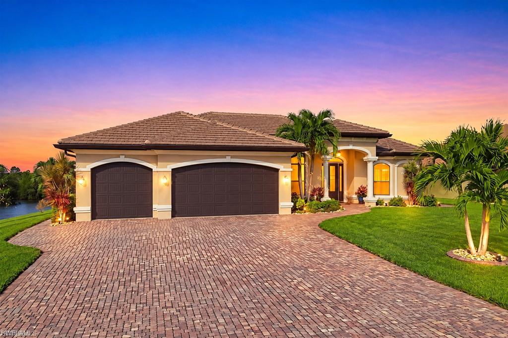 SPECTACULAR DIRECT GULF-ACCESS WATERFRONT TRIPLE LOT WITH PANORAMIC VIEWS AND 250 FEET OF SEAWALL!  No Flood Insurance required and only 5 minutes to open water! ALL ASSESSMENT ARE PAID IN FULL! This stunning 3-bedroom, 3.5-bathroom residence also offers MAGNIFICENT views of the Northwest Spreader, pristine natural mangroves and million dollar western sunset views!  Closest lot on the spreader to get out to the open waters and within walking distance to Joe Stonis Park, Tropicana Park and just a few steps away from Sirenia Vista Park with its kayak launch, beautiful butterfly garden and easy access to the 190 mile Great Calusa Blueway - a guided kayak and paddleboarding trail. Offering direct, bridge-free access to open water and the Gulf, this remarkable property is a boater’s dream! Talk about curb appeal - meticulous and lush tropical landscaping with six zones and low water bills - both pool and irrigation are filled by well. an expansive paver driveway, elegant architectural columns, and a spacious three-car garage. Step through the impressive 8-foot hurricane-rated front door into a beautifully designed interior featuring soaring ceilings, decorative tray ceiling accents, graceful archways, and abundant natural light. The open-concept living areas flow seamlessly into a sophisticated kitchen appointed with rich wood cabinetry, stone countertops, built-in wall ovens, a center island with a prep sink, and an expansive breakfast bar illuminated by stylish pendant lighting. Flexible and fun layout with two generously sized primary suites, each offering direct access to the lanai for added comfort and convenience. Step outside to an incredible outdoor living experience, where a spectacular infinity-edge pool overlooks the tranquil waterway and an expansive screened lanai creates the perfect setting for relaxation and entertaining. A beautifully integrated OUTDOOR KITCHEN enhances the space, making alfresco dining, weekend gatherings, and poolside celebrations effortless while enjoying the refreshing coastal breezes. Boating enthusiasts will appreciate the private dock with a 10,000-pound boat lift, providing convenient access to some of Southwest Florida’s most sought-after waterways. The oversized grounds offer generous green space, manicured tropical landscaping, and an impressive sense of openness rarely found in waterfront properties. Additional features include a conveniently located laundry area and thoughtfully planned garage access. As evening falls, the home's architectural lighting creates a captivating ambiance that complements its elegant exterior and picturesque surroundings. Most furnishings are negotiable and available via separate bill of sale. A RARE OPPORTUNITY TO EXPERIENCE REFINED COASTAL LIVING, OUTSTANDING BOATING ACCESS, AND THE BEAUTY OF CAPE CORAL’S WESTERN WATERFRONT!