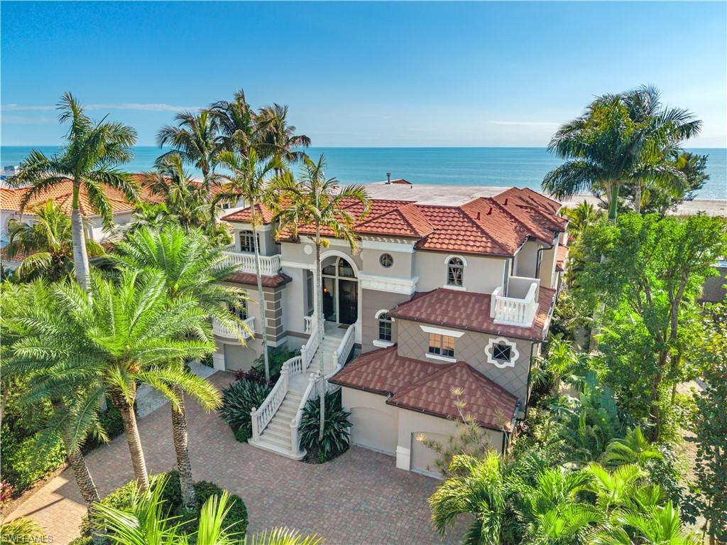 Majestic Gulf-front estate located on West Gulf Drive, Sanibel Island’s most coveted and prestigious beachfront address. Widely regarded as the premier location on the island, West Gulf Drive offers expansive estate-sized parcels, exceptional privacy, no HOA restrictions, and some of the quietest, least-traveled beaches on Sanibel. For those seeking the finest beachfront living, this is simply where you want to be. Set back from both the road and the shoreline, the property enjoys a rare sense of seclusion while maintaining breathtaking, unobstructed Gulf of Mexico views and spectacular sunsets. Elevated for peace of mind, the approach is framed by lush, tropical landscaping that immediately sets the tone, private, serene, and resort-like from the moment you arrive. The residence blends Sanibel’s relaxed coastal charm with the refined architectural presence often associated with Palm Beach and Naples, elegant yet approachable, luxurious without pretense. Designed to function as a true home rather than a showpiece alone, the interior is warm, inviting, and ideal for entertaining, extended family stays, and memorable gatherings. Upon entry, the volume of the main living area is immediately felt, highlighted by soaring beam ceilings, remarkable architectural detailing, and exquisite millwork throughout. The design strikes a perfect balance between formal and casual, grand in scale yet comfortable and livable, with a flow that feels both intentional and effortless. Mediterranean-inspired architecture gives the home a timeless character, complemented by expansive indoor and outdoor living spaces. Multiple lanais and deck areas invite effortless Gulf-front living, while the tranquil, resort-style pool area offers a peaceful retreat with sweeping water views and unforgettable sunsets. This meticulously built estate includes luxury amenities expected at this caliber, including an elevator, multiple game and recreation rooms, wine room, theater, office, indoor and outdoor kitchens, and flexible spaces for optional additional bedrooms. Professionally decorated with custom-designed furnishings, the residence is offered fully appointed, creating a rare turnkey opportunity. A true family compound and legacy property, this extraordinary West Gulf Drive estate offers unmatched privacy, prestige, and livability in one of Sanibel Island’s most iconic beachfront settings.