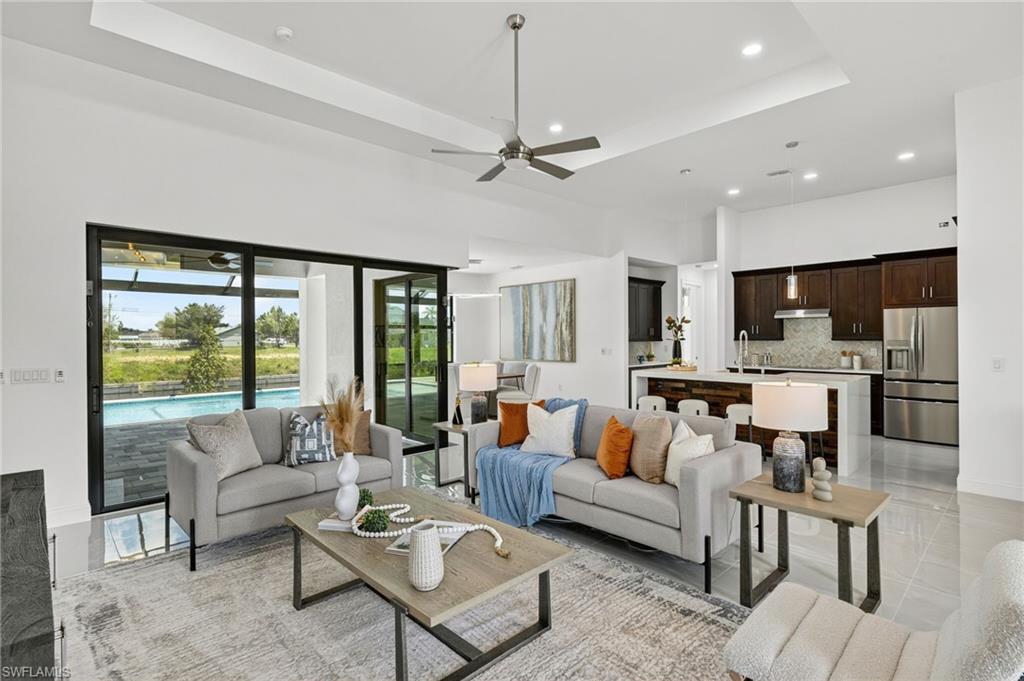 Move-in ready! This brand-new 3 bedroom + den, 3 bath, pool home sits on a freshwater canal in a prime Cape Coral location. Inside, you’ll find high ceilings, expansive windows, tile floors, and a beautiful kitchen with quartz countertops, custom cabinets, and stainless appliances.  The primary suite offers two walk-in closets along with a sizable bathroom with dual vanities, a soaking tub and a walk-through shower. In the living area, the zero corner sliding glass doors offer seamless entertainment space from inside out to your screened lanai with a sparkling pool, outdoor kitchen, and spacious paver deck. Built for peace of mind with impact windows/doors, a durable tile roof, and flood zone X. Enjoy fishing the freshwater canals right from your backyard.  Convenient access to shopping, dining, golf, and entertainment!