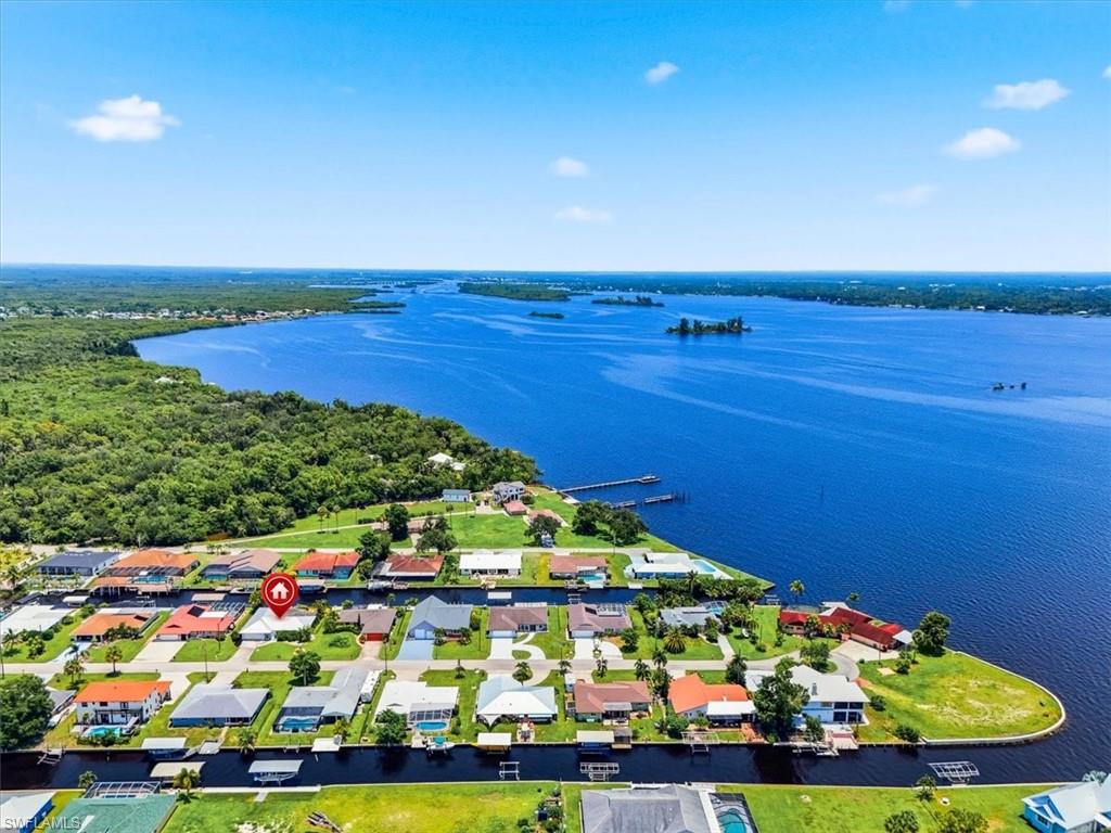 Welcome to 7211 Reymoor Drive, North Fort Myers, FL 33917.  DIRECT GULF ACCESS WITH NO BRIDGES! Enjoy waterfront living at 7211 Reymoor Dr., just six residences from open water along a wide canal. This remodeled 3-bedroom, 2-bath home offers 1,878 square feet of living space, a split-bedroom floor plan, and an attached 2-car garage. The updated kitchen features new white cabinetry, granite countertops, stainless steel appliances, and a tray ceiling, creating an inviting space for everyday meals and entertaining. Upgraded ceiling fans and a metal roof complement the home’s refreshed appeal. Relax on the spacious screened lanai overlooking the canal, or head to your private concrete dock with electricity and water available. Enjoy boating access to the Caloosahatchee River and the waterfront destinations of downtown Fort Myers. Situated on approximately .28 acres, the property also features a fenced yard, tile flooring, and an interior laundry area. With no HOA fees, this home combines updated interiors, comfortable outdoor living, and convenient access to Southwest Florida’s waterways. SELECT PHOTOS HAVE BEEN VIRTUALLY STAGED OR DIGITALLY ENHANCED. VIRTUAL FURNISHINGS AND DECOR ARE NOT INCLUDED IN THE SALE.