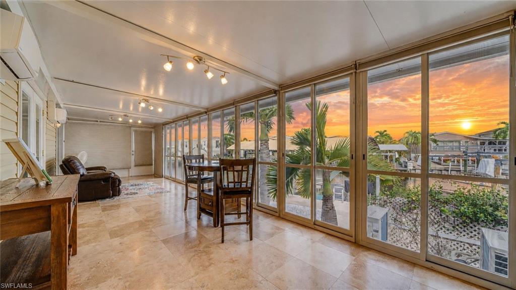 One of the largest waterfront properties in St. James Isles, formerly known as Cherry Estates, this oversized homesite offers an exceptional combination of space, premier boating amenities, and island living that is rarely available. Situated on deep, direct Gulf access waterfront with no bridges, you'll enjoy quick, unrestricted access to Pine Island Sound, world-class fishing, and the Gulf waters beyond. Boasting 107 feet of waterfront with a new seawall installed in 2015, this property is designed for those who want to embrace the ultimate Southwest Florida boating lifestyle. A gated, fenced side yard features a dedicated parking concrete pad for up to a 25-foot RV, while the expansive lot still offers plenty of room to add a pool. The composite dock is equipped with water, electric, and a convenient fish cleaning station, along with a 7,500-pound covered boat lift and a 4,500-pound uncovered boat lift, making it easy to accommodate multiple boats or watercraft. An oversized outdoor shower makes rinsing off after a day on the water easy. Inside, the home offers 3 bedrooms, 2 full baths, an enclosed lanai with two new 2026 mini-split systems, an in-residence laundry room, and a spacious primary suite featuring a walk-in closet, dual-sink vanity, and walk-in shower. The kitchen features white raised-panel cabinetry, a center island, a stainless steel refrigerator, pantry, and abundant workspace. Thoughtful upgrades continue throughout the home with California-style shelving in every closet and pantry, providing exceptional organization and storage. Major improvements completed in 2023 include a new roof, vinyl siding, air conditioning system, water heater, deep two-car carport, and a new roof over the attached workshop. The exterior is finished with decorative concrete around the entire perimeter, creating a clean, finished appearance that sets it apart from traditional skirting. Additional highlights include an attached workshop with loft, an air-conditioned Amazon storage shed, Bahama-style hurricane shutters on most windows, a hardwired security system with battery backup, a deep paver carport, and a beautifully finished paver backyard perfect for relaxing or entertaining. For added peace of mind, the home has never experienced storm surge water inside. Whether you're cruising to the world-famous beaches of Sanibel, Captiva, North Captiva, Cayo Costa, Boca Grande, and Cabbage Key or heading to the legendary fishing grounds of Pine Island Sound, renowned for outstanding tarpon, snook, redfish, and trout fishing, this property offers the true Southwest Florida boating lifestyle. With one of the largest lots in St. James Isles, deep direct Gulf access, abundant parking and storage, and exceptional waterfront amenities, this is a rare opportunity to own your own island retreat.