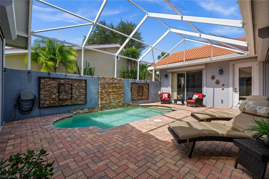 Great in town opportunity at a great price 3 bath 3 bed pool home, private resort-style setting in one of Naples’ most convenient locations in World Tennis Center, Electric shutters provide added security & roof has been recently cleaned & sealed w/ guarantee. Investors & part time residents take note 30 day rental period provides even more options. At the heart of the property, a sparkling pool with a dramatic waterfall feature creates a tranquil focal point, while the surrounding brick-paver courtyard provides multiple spaces for lounging, dining, and entertaining in complete privacy. A detached cabana- guest suite—complete with its own bedroom and full bath—offers exceptional flexibility for guests, extended family, a home office, or private retreat. Inside, the light-filled living room, anchored by a striking electric fireplace, flows effortlessly into the kitchen and dining areas. The kitchen is thoughtfully appointed with rich granite countertops, abundant cabinetry, a breakfast bar, and an adjacent dining space. Wood-style flooring, volume ceilings, and walls of glass overlooking the courtyard enhance the home’s warm yet refined atmosphere. The spacious primary suite offers direct access to the courtyard and pool area, while the en-suite bath features dual vanities, a soaking tub, and a separate shower. A generous guest suite within the main residence provides additional comfort and privacy for family and visitors alike with its own bath. Beyond the courtyard, an open brick-paver patio off the dining area creates yet another inviting outdoor gathering space.
Residents enjoy an exceptional amenity package centered around its renowned tennis facilities, including multiple Har-Tru courts, professional instruction, league play, and an active social calendar. Additional amenities include a resort-style pool and spa, clubhouse, fitness center, pickleball, basketball, walking paths, and beautifully landscaped grounds. Combining privacy, flexibility, and a coveted central Naples location, just minutes from white-sand Gulf beaches, Waterside Shops, Mercato, downtown Naples, exceptional dining, shopping, and cultural attractions.