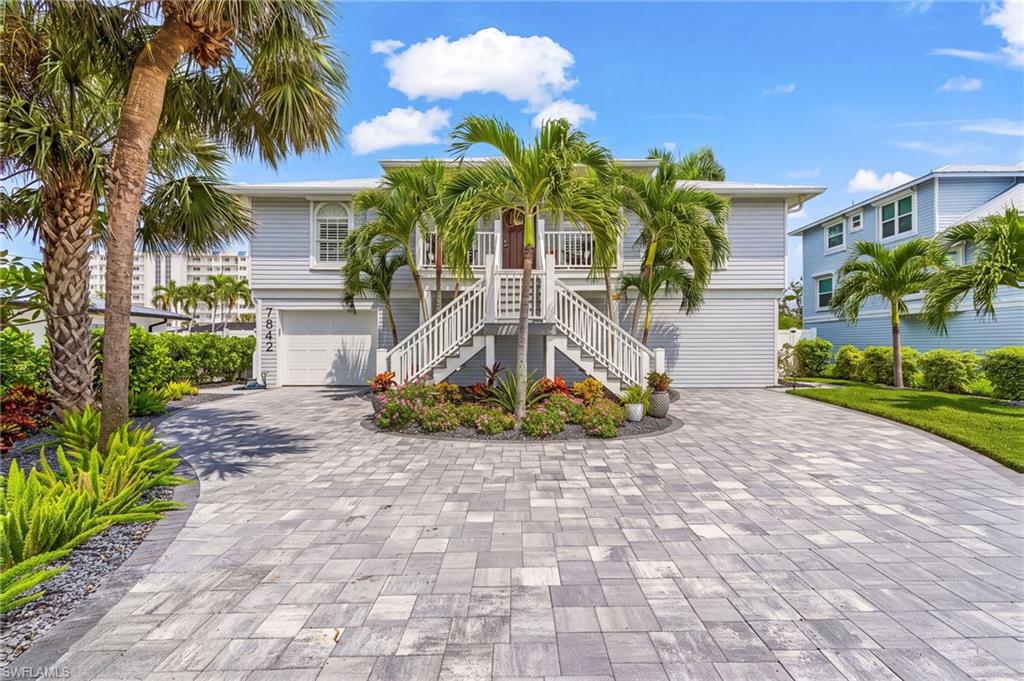 UNIQUE OPPORTUNITY! Located on the quiet South End of Estero Island, this stunning property offers a resort-like experience, with partial Gulf views and beach access just across the street. The elevated construction of this meticulously updated and maintained home, presents a unique opportunity to indulge in the coastal lifestyle, while the ELEVATOR, Metal Roof, upgraded Pavers, composite Decking, Automated features including lighting and irrigation, custom tile inlays in the salt water POOL & SPA, and 2-story Enclosure create a captivating outdoor space. The interior boasts a modern kitchen, with new solid wood cabinets, quartz countertops and sleek stainless appliances, including a beverage fridge, in the large island. Complemented by a 36 inch cooktop with vent hood, and engineered wood floors throughout. The renovated primary bathroom ensuite is a peaceful retreat, with dual sinks, stand alone soaking tub and separate tiled shower. With convenient access to Lover's Key, Bonita Springs, and Naples, this property is a captivating blend of luxury and coastal convenience. This is a MUST SEE property with a separate apartment downstairs. The fully renovated "Cabana/Guest house" has Two Bedrooms, a full Bath, full Kitchen Plus additional Living and storage space, with separate mini splits and tankless Hot Water Heater, Concrete, Epoxy and Plank Tile Flooring. Some other recent improvements include, NEW HVAC Reverse Osmosis water system upstairs, Remote Controlled Storm Shutters (except 3 windows accordian: 2 front, 1 back), Remote Controlled Awnings by Pool (POOL completely redone in 2023), Automated Landscape Irrigation (well shared with neighbor) and Lighting, Automated Pool/Spa System with App, 2 Story Enclosure with Super Gutters & Super Screens), 125 gallon propane tank for pool heater & BBQ Grills.