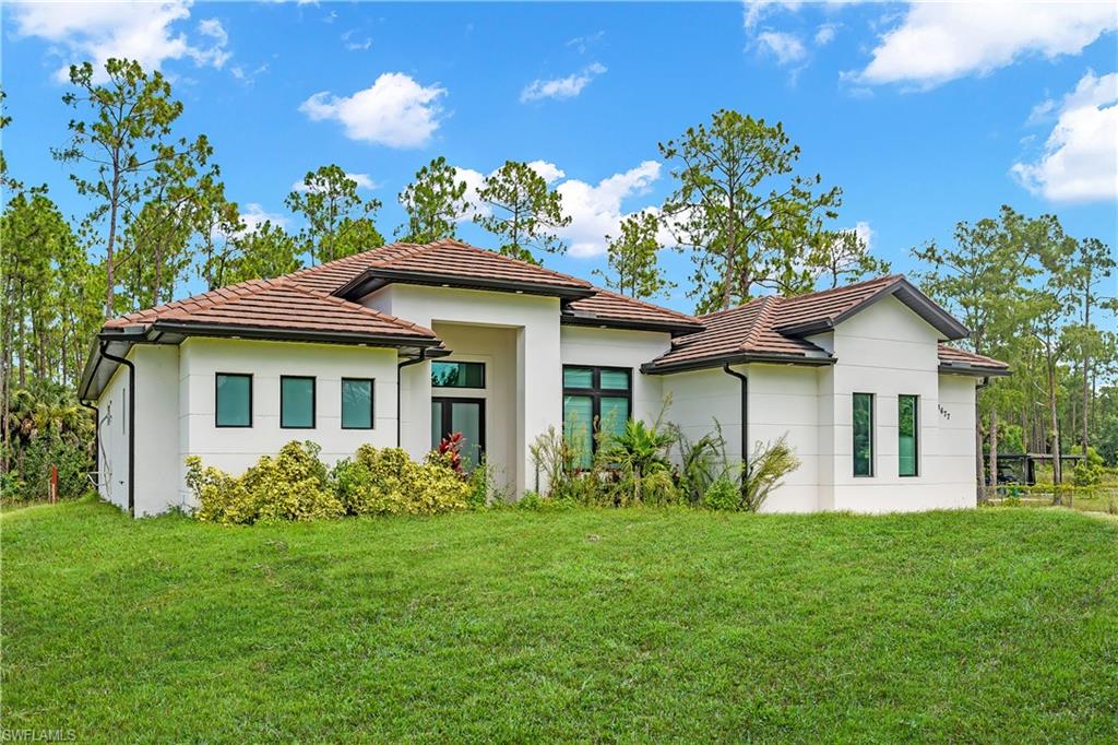 LIKE-NEW HOME ON 2.41 ACRES! This beautiful 3-bedroom + den, 2-bath home with a 2-car garage offers the perfect combination of space, comfort, privacy, and modern finishes.

Step inside to a bright and open floor plan featuring spacious living and dining areas, impact-resistant windows, granite countertops, stainless steel appliances, tile flooring throughout, and a desirable split-bedroom layout.

The primary suite includes a walk-in closet and tray ceiling, while additional features include an automatic irrigation system, asphalt driveway, and plenty of outdoor space for your family, pets, recreational vehicles, or future improvements.

Situated on a generous 2.41-acre lot, this property offers exceptional privacy while still being conveniently located near schools, shopping, dining, and everyday necessities.

Move-in ready and beautifully maintained — bring your family and make this wonderful property your next home!