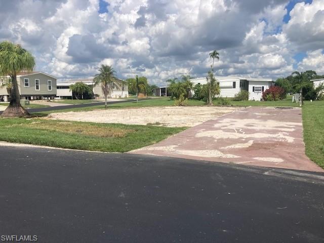 Large corner lot will hold a 1,500 sq. ft. home easily. Place a new home on this lot and enjoy the beauty of a community where you have a view of the Caloosahatchee River.  Price includes share for lot and ownership in co-op. Low monthly fee of $406 includes water/sewer, trash collection, lawn mowing/edging, private gate, fiber optic Internet, and all amenities in the community. Orange Harbor is a 55+ resident-owned, waterfront, pet friendly community with heated pool, pickleball, shuffleboard, bocce ball and many groups and activities and is located close to I-75, shopping, restaurants, Manatee Park and downtown Ft. Myers. Two pets total per household. Some dog breeds are prohibited so be sure to review the community rules. ESA or service animals are allowed.