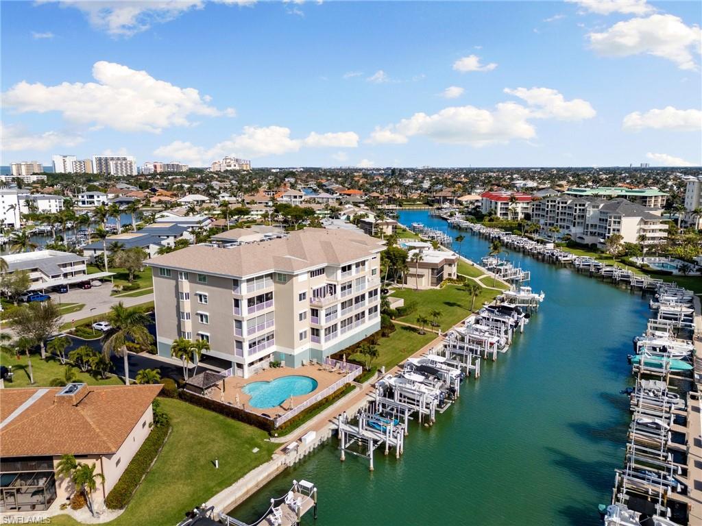 Welcome to your dream condo on the picturesque south end of Marco Island at Maxime Club #303! This beautifully maintained 3-bedroom, 2-bathroom unit offers a serene canal view, making it the perfect retreat for those seeking a blend of luxury and tranquility. With 1,810 square feet of living space, you'll feel right at home. The spacious master bedroom is a sanctuary of comfort, featuring not one, but two generous closets for ample storage. The en-suite master bathroom is a true highlight, boasting double sinks for added convenience, a separate tub for relaxation, an independent shower, and an enclosed toilet room for privacy. The guest bedrooms are perfect for guests or family, offering comfort and space. The entire unit features elegant tile flooring, offering a clean and modern aesthetic while being easy to maintain. The eastern-facing lanai has electric shutters, providing ease and security at the touch of a button. The windows come with manual shutters, offering additional protection and peace of mind. Enjoy the benefits of a freshly replaced seawall (Nov 2020) and docks (Dec 2020), ensuring the property is well-prepared for waterfront living. Boat dock #4, a brand new 12,000 lb boat lift was installed in February 2023, making this condo ideal for boating enthusiasts. The unit comes with a modern air conditioning system installed in 2018 and a new hot water heater installed in 2023, ensuring comfort and efficiency throughout the year. New garbage disposal installed 2026. Maxime Club has a wonderful pool area, BBQ, Cabana, bike racks, assigned covered parking, large dedicated storage #6, and more. Embrace the island lifestyle in this exquisite condo that perfectly balances luxury, comfort, and convenience. Building was painted spring of 2026 and garage area flooring was resurfaced. Don't miss the chance to make this exceptional property your new home!
