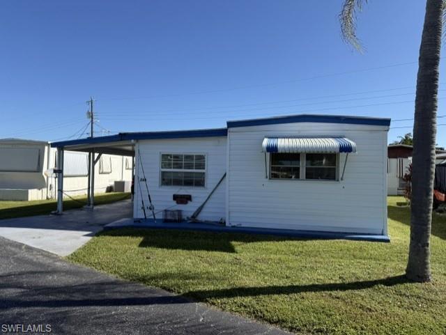 Welcome to Sun-N-Fun Mobile Home Village, an active 55+ community offering a relaxed Florida lifestyle with an abundance of amenities and activities! This 2 bedroom, 1.5 bath home is being offered furnished with some additional extras and offers a versatile layout with a den, office, and enclosed porch providing plenty of space for relaxing, hobbies, or working from home. The convenient half bath is located off the covered porch and office area.  Outside, you'll find a workshop complete with tools, along with covered parking for your vehicle and golf cart. The golf cart and 2010 Ford Escape are also negotiable, providing the opportunity to make your move even easier. TPO roof system 2021. Best of all, there is no additional lot rent, and the community offers low monthly HOA fees. Sun-N-Fun provides an impressive array of amenities and activities, including a community pool, shuffleboard, bocce ball, putting green, fishing pier, community boat ramp, boat and RV storage, 9-hole golf course, and so much more.
