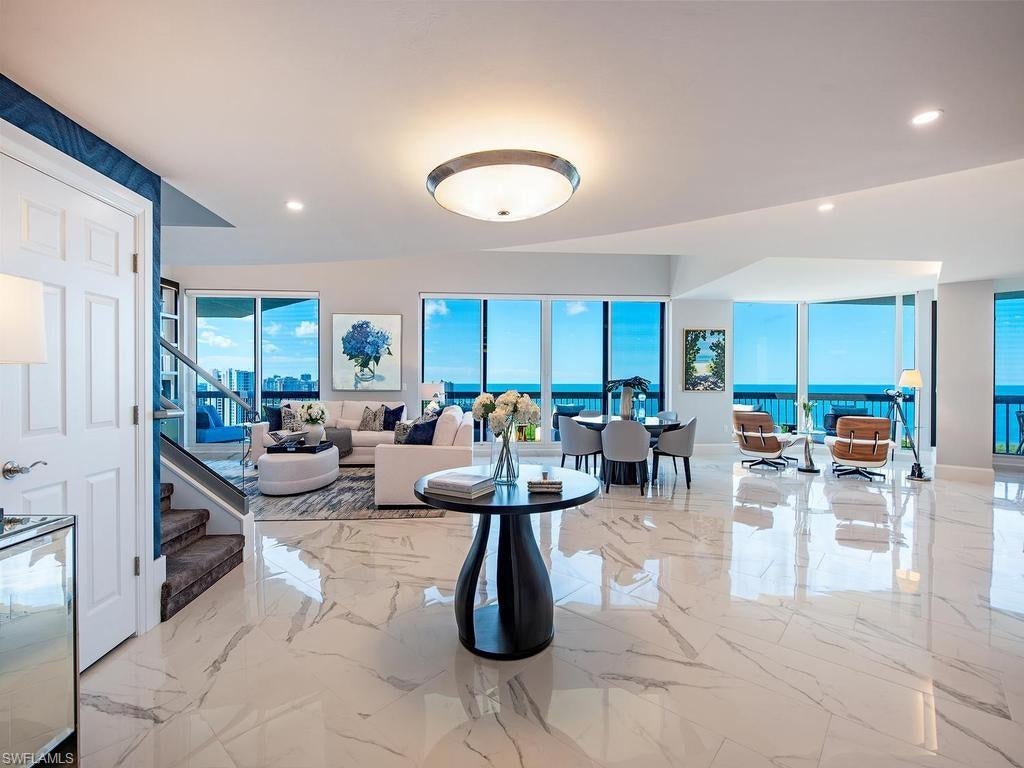 Seeking PERFECTION? Capture this rare opportunity to own a legacy two-story Grosvenor penthouse, a 2024 Sand Dollar Award winner and true CROWN JEWEL. Showcasing nearly 6,000 square feet of beautifully remastered interior living space, this extraordinary residence commands equally magnificent, unobstructed panoramic southwest views of the Gulf, preserve, and sparkling city lights, complemented by the security of ALL NEW hurricane-impact windows and doors! This exceptional residence features TWO luxurious Owner's Suites, one on each level, with a versatile floor plan designed for sophisticated yet relaxed living, whether for a couple, extended family, or multiple generations. The expansive main level offers gracious, luxurious living on its own, while the spectacular second level provides inviting gathering and private retreat spaces, including a second grand Owner's Suite, an adjoining media/game loft affectionately known as "The Nest," and two private guest bedrooms. Dramatic daily sunsets and nature's ever-changing coastal cloudscapes create a breathtaking backdrop, beautifully framed by expansive walls of glass and enjoyed from private, covered open-air lanais on both levels. Two secure under-building parking spaces and private storage on the same level complete this truly exceptional offering. The Remastering of Grosvenor’s Arrival Lobby, Social Gathering and Board Room, Catering Kitchen, and Fitness is now complete, complementing Grosvenor’s sunny resort-style pool, spa and expansive open-air pool deck. Added to these fabulous Tower amenities is a full menu of included World Class Pelican Bay private membership privileges: 2 private Beachfront Beach and Dining Clubs to call your own, 2½ miles of pristine sugar white sandy beach, attended Beachfront services, 2 active Tennis Clubs, State-of-the-Art Fitness, miles of biking and walking paths and a lively, active calendar of social events! Artis Center for the Performing Arts and bustling Mercato both just steps away.