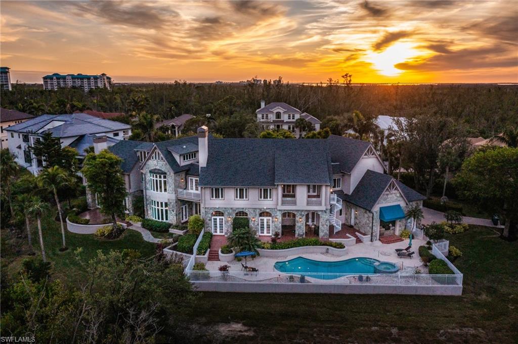 Welcome to the pinnacle of SWFL communities in the Gulf Access private marina community of St. Charles Harbour. This exceptional CBS and stone-constructed London Bay estate home is set on a sprawling 1.16-acre lot—one of the largest and most unique properties in Southwest Florida. Thoughtfully designed with 5 spacious bedrooms, a den plus huge office, 6.5 bathrooms, and an expansive 3-car garage with golf cart space and a car lift, this fortress-like home exudes sophistication and functionality. Inside, you’ll find a gorgeous spiral staircase, detailed moldings throughout, abundant windows that bathe every room in natural light and frame the gorgeous views, kitchen cabinets with pull-out drawers, and exquisite white oak ceilings and quarry tile floors that showcase unparalleled craftsmanship and timeless elegance. The spacious rec room provides the perfect space for entertaining, relaxation, or hobbies. The exterior of the property boasts beautiful curb appeal with striking stonework, elegant arches, mature landscaping, a newer roof (2022), newer hot water heater, new disposal, and a freshly epoxied garage floor, welcoming you to this one-of-a-kind home. Outdoors, the property transforms into an entertainer’s paradise with a sparkling pool and spa. Boating enthusiasts will love that the optional Yacht Club membership adds exclusive access to the clubhouse, private activities, and Gulf access, while golf enthusiasts will appreciate the convenience of Shell Point Golf Course next door. With transferable flood insurance, no water damage, and flawless move-in-ready condition, this home is a rare find in every sense. This extraordinary property’s beauty, sophistication, and unique amenities must be seen to be fully appreciated. Don’t miss this once-in-a-lifetime opportunity to experience the very best of Southwest Florida living.