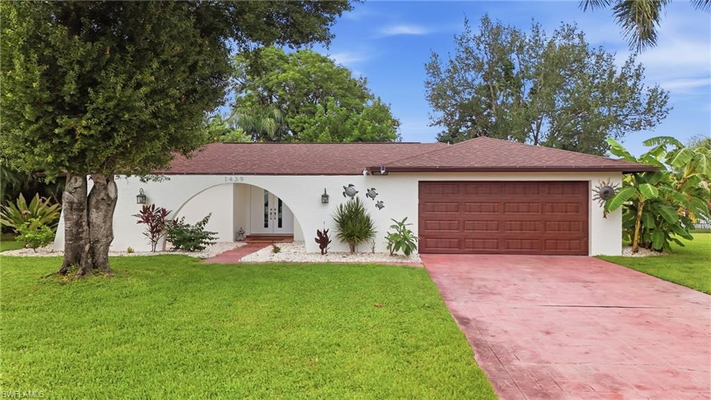 Welcome to 1439 Claret Ct., tucked within the highly sought-after Whiskey Creek neighborhood. With multiple living and dining spaces, a private saltwater pool and a generously sized backyard, this home offers the flexibility to make every space your own. Step through the double-door entry into a bright interior featuring tile flooring throughout, where a formal living room, formal dining area and separate family room provide plenty of room to entertain, relax or create distinct spaces for everyday living. The kitchen features granite countertops, abundant cabinetry, stainless steel appliances and a stylish tile backsplash, while its connection to the family room keeps the space open and functional. There is even room to add a small breakfast table or casual dining area, giving you another option for morning coffee or everyday meals. At the heart of the family room is the wood-burning fireplace—a unique and unexpected feature for a Southwest Florida home that adds warmth, character and a cozy gathering spot when those cooler Florida evenings arrive. This home truly embraces indoor-outdoor living, with sliding glass doors from the formal living room, family room and primary bedroom all providing direct access to the pool area. Step outside to the expansive covered lanai and saltwater pool, where there is plenty of space to create outdoor living and dining areas for relaxing and entertaining year-round. Beyond the pool, the large backyard is enclosed by a wall with iron gates rather than a traditional fence, adding privacy and character while leaving plenty of room to create your own outdoor oasis. Add gardens, additional seating or entertaining areas and make the space your own. The formal dining room offers another unique opportunity, with (newly installed) impact French doors opening to the front courtyard area. Imagine transforming this space into a charming front patio with café seating, landscaping or a quiet spot for morning coffee or evening cocktails. The primary suite enjoys direct access to the pool area, while the additional bedrooms offer flexibility for family, guests, a home office or hobby space. A large laundry room and two-car garage add everyday functionality. The interior was just freshly painted, creating a clean, neutral canvas ready for your own furniture, décor and personal style. Major improvements include a 2022 Roof and Garage Door, 2021 A/C, 2023 Pool Pump, 2019 Pool Resurfacing & Paver Decking, and impact windows and sliders installed throughout in 2025. Additional updates include a new exterior access door off the garage and refreshed exterior paint. And there is another important benefit: No Flood Insurance required. With generous living spaces, extensive storm protection, a private saltwater pool, covered outdoor living, a large backyard and a floor plan offering so many possibilities, 1439 Claret Ct. is a clean canvas ready for your personal style and your own vision of the Southwest Florida lifestyle.