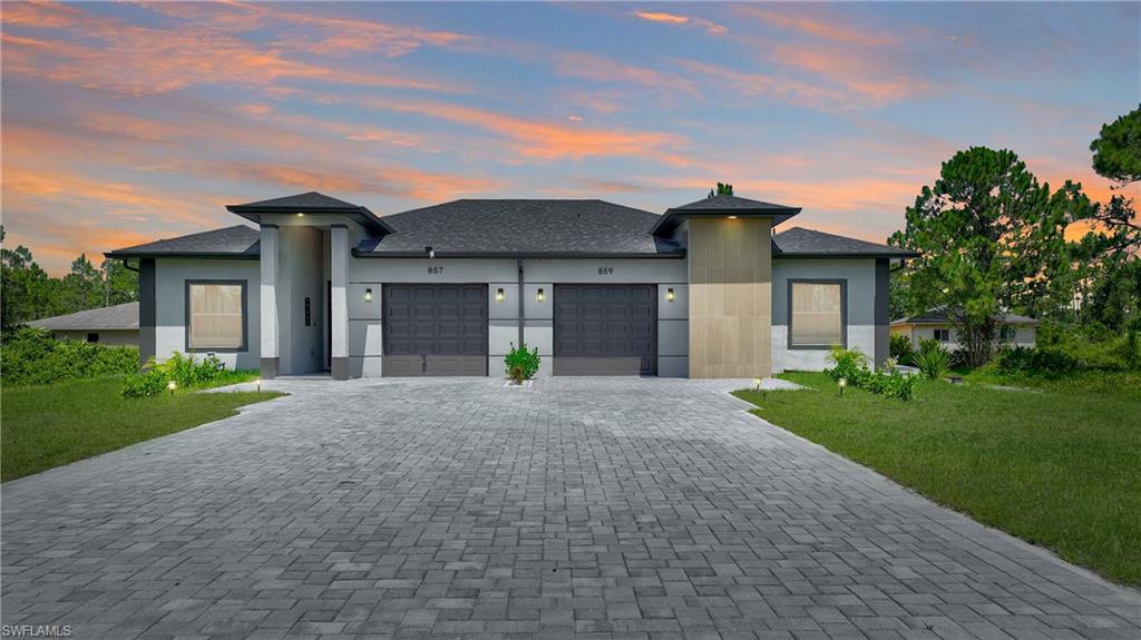 Spacious duplex built in 2024 in Lehigh Acres, conveniently located near State Road 82, shopping, and schools. Featuring 9.4-foot ceilings, a contemporary open-concept layout, spacious bedrooms, and modern finishes throughout. Additional features include tile flooring, concrete block construction, impact-resistant windows, and a screened lanai for enjoying the outdoor space.