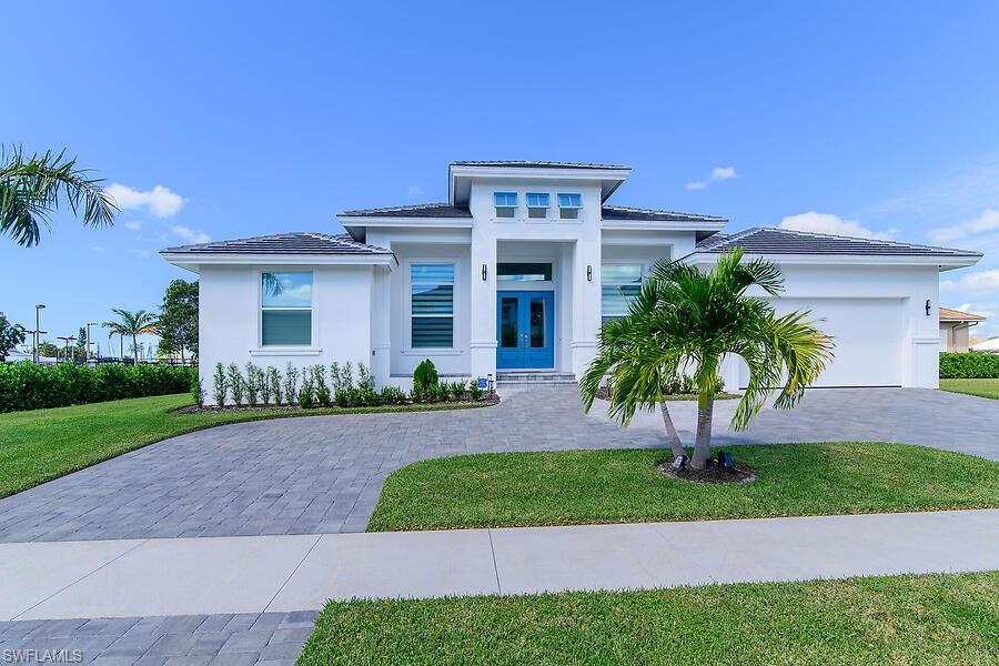 This beautiful, coastal contemporary, newer home is full of upgrades. This newly landscaped homes includes 4 bedrooms, 3 bathrooms, large great room, kitchen and dining area overlooking the pool and spa and has a 2-car garage with over-sized driveway. This home boasts high ceilings, 8' sliders, impact windows, outdoor summer kitchen, and covered lanai. The bright, open concept design includes upgraded kitchen cabinets, quartz countertops, large island, walk-in pantry, and tile flooring throughout. The owner's suite has 2 walk-in closets and separate vanities. This beautiful property is located just minutes to the white sand beaches of Marco Island, parks, tennis and pickle ball courts, golf, shopping, dining, schools, and the YMCA.