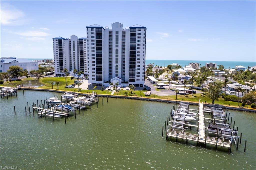 Experience breathtaking Gulf and Back Bay views from this beautifully remodeled 8th-floor residence at Ocean Harbor. This stunning condominium has been completely updated with a redesigned open-concept layout, including the removal of the kitchen wall to create a spacious and inviting living area perfect for entertaining and enjoying the waterfront scenery. The beautifully renovated kitchen flows seamlessly into the main living space, while the updated bathrooms offer a clean coastal feel with quality finishes throughout. Impact glass windows and sliders provide peace of mind and enhance the natural light from every angle. Offered furnished, this residence is ready for immediate enjoyment. Enjoy spectacular sunrises over the Back Bay and unforgettable Gulf sunsets from one of Fort Myers Beach’s most beautifully maintained gated communities, featuring lush tropical grounds, marina access, deeded beach access, pickleball, tennis, clubhouse amenities, and more.