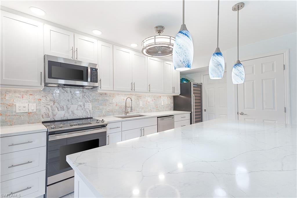 LOCATION, LOCATION, LOCATION! If you are searching for your winter getaway OR for your permanent Florida home, this COMPLETELY UPDATED 2BR/2BA unit located in the coveted community of Hacienda Village will NOT disappoint…MINUTES from Downtown Bonita Springs AND Bonita Beach! Over 1,500 square feet of living space, THIS unit lives like a single-family home! Home boasts stainless appliances, quartz countertops, shaker cabinets, tile flooring throughout the first floor, luxury vinyl tile throughout the second floor AND SO MUCH MORE!  Spend those cool Florida winters enjoying coffee on your lanai while admiring the lush landscaping.  Stargaze on your second-floor balcony while sipping your favorite cocktail. You will LOVE entertaining family and friends as this open concept layout is designed for just that! PLUS, Hacienda Village offers SO many amenities – tennis, pickleball, and a community pool just to name a few – AND LOW HOA fees! You will be WOWED upon entering the community as it is SO WELL maintained! Bike OR walk to Downtown Bonita Springs from your front door! The burgeoning Downtown Bonita Springs boasts eclectic restaurants, coffee/wine bars, craft cocktail bars, craft breweries and a new music venue. The arts are alive in Bonita, with plenty of festivals, artist cottages, music in the downtown amphitheater. PLUS, only a 10-minute drive to Barefoot Beach. DO NOT miss YOUR opportunity to experience all that Bonita Springs has to offer, not only in a community, but especially in a HOME!