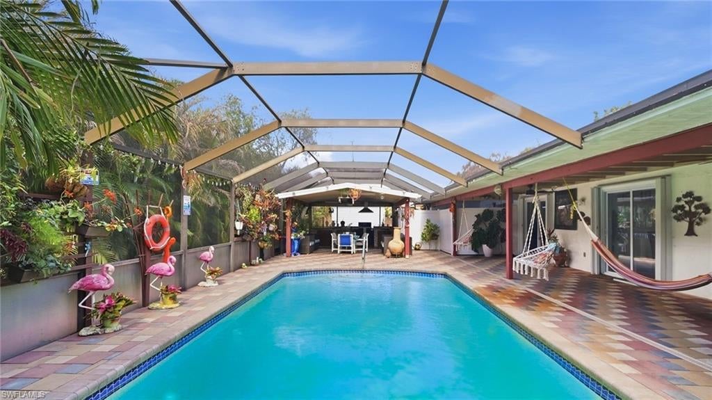 This beautifully renovated, move-in-ready, 2,100-square-foot home features a mother-in-law suite with a private entrance. The main living area includes three bedrooms, two bathrooms, an upgraded kitchen with stainless steel appliances, laminate flooring throughout, and a custom entertainment center. The exterior offers a backyard retreat complete with a pavered pool deck, a pool cage, and a custom pergola featuring a kitchen area for entertaining. The pool is solar-heated, and the home is equipped with storm shutters throughout. The mother-in-law suite includes its own kitchen, laundry washer and dryer, and a private room with ample natural lighting. Concessions available.