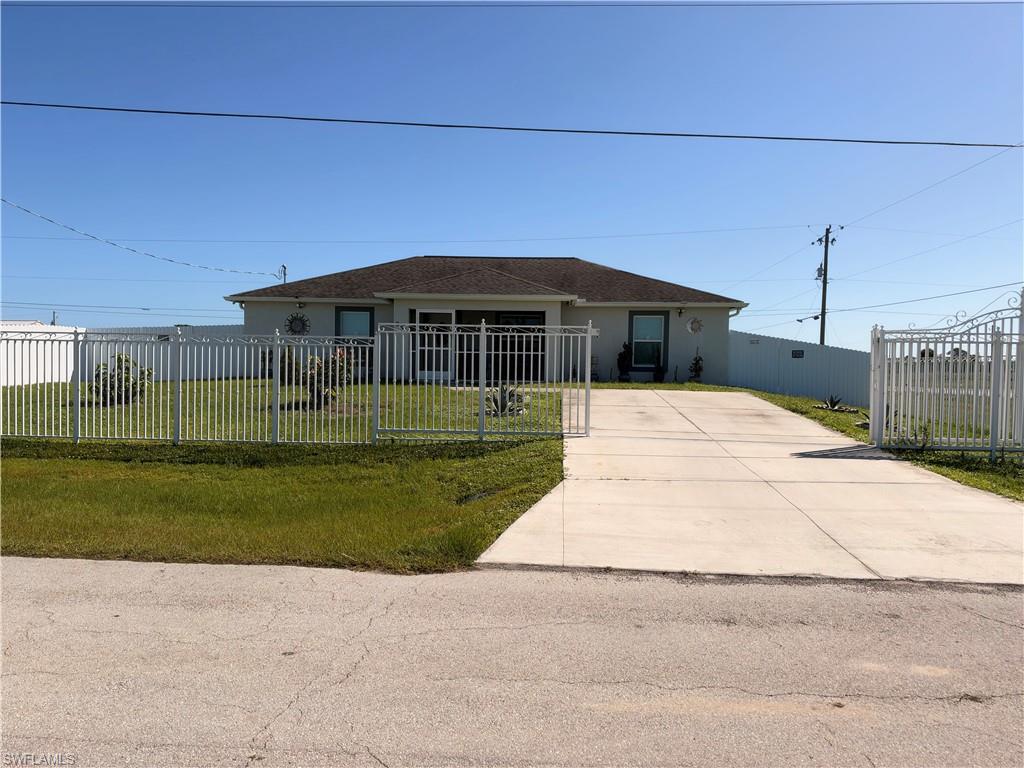 Beautifully Maintained 4-Bedroom Home with Additional Lot and Exceptional Outdoor Living! Discover this charming 4-bedroom, 2-bath home built in 2019, offering approximately 1,500 square feet of living space, thoughtful upgrades, and plenty of room to enjoy the Florida lifestyle! Situated on a fully fenced corner property with an additional lot, this home offers extra space for your recreational vehicles, boat, outdoor activities, or a potential future garage. Step inside to an inviting interior featuring porcelain tile flooring throughout, granite countertops, custom-built closets, and a comfortable, functional layout. One of the home's standout features is the expansive screened lanai spanning the length of the home, complete with a built-in grill, bar, and sink—an ideal space for entertaining or simply relaxing outdoors. A screened front entry adds another touch of convenience. The spacious yard is filled with an impressive variety of established fruit trees, including mango, guava, citrus, ciruela, and sugar apple (anón), creating your very own tropical retreat. Additional features include a front aluminum gate, fully fenced yard, and concrete driveway. The additional lot provides exciting possibilities for future improvements,Built in 2019 and offering a wonderful combination of indoor comfort, outdoor living, and extra land, this property is a fantastic opportunity to enjoy country-style living in LaBelle. Schedule your private showing today and discover everything this unique property has to offer!