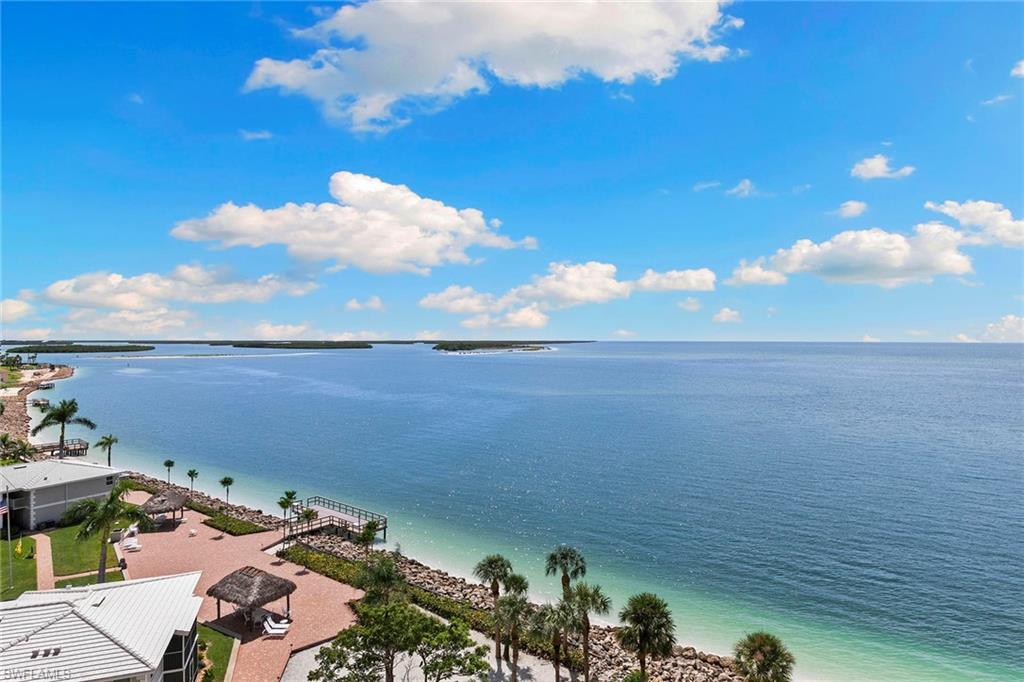 Take in breathtaking Gulf views from this furnished eighth-floor condominium with two bedrooms, a den, and two baths. Recently renovated throughout, the residence features high-end upgrades and tasteful interiors done by renowned Naples designer Betsy Hendricks. The open living and dining area connects to a kitchen with custom cabinetry and a breakfast bar. Accessible from both the living area and primary suite, the open lanai expands the living space and offers stunning views. Wood-look tile flooring extends throughout, while impact-resistant windows and electric shutters provide added protection and convenience. Set within a gated community on Marco Island's quiet south end, residents enjoy a social room, pool and spa, sauna, tennis and pickleball courts, barbecue area, fire pit, private beach, expansive fishing pier, covered parking, and additional storage. Nearby shopping, dining, and entertainment make island living effortless.