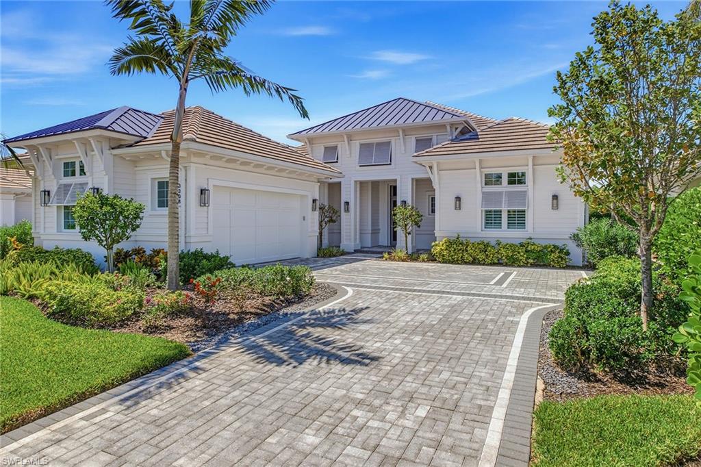 Experience the elegance of a home that is virtually new without stress of the building process. Barely lived in, extensively upgraded, immaculately maintained and offered negotiable, this quality-built Gulf Bay Homes Hibiscus floor plan was completed in 2023 and is ready to move in and enjoy. The exceptional light-filled layout offers four bedrooms plus a den, three full baths, one half bath and 3,139 square feet under air, with preferred southern exposure and tranquil lake views. A dramatic foyer with a coffered shiplap ceiling, engineered oak flooring and a glass entry door introduces the home’s design. The open-concept great room features a natural gas fireplace with glass tile surround, custom built-ins, a wet bar with U-Line wine refrigerator, in-ceiling speakers and pocketing impact-glass sliders that seamlessly connect to the lanai. Designed for entertaining, the gourmet kitchen impresses with quartz counters, custom white cabinetry, under-cabinet lighting and a large graphite island. Premium appliances include a Bosch Wi-Fi-enabled built-in refrigerator, double convection ovens, drawer microwave, natural gas five-burner cooktop and vent hood. A walk-in pantry and Grohe fixtures complete the space. The primary suite offers lanai access, two custom walk-in closets and a spa-inspired bath with a freestanding soaking tub, oversized frameless-glass shower with floor-to-ceiling tile, dual quartz vanities and premium Grohe and Toto fixtures. Three guest bedrooms, including a private en suite, provide comfortable accommodations, while the den is ideal for a home office or quiet retreat. Florida living takes center stage on more than 600 square feet of covered lanai space with natural stone pavers, a soaring wood-accent ceiling, in-ceiling speakers, Bahama shutters and electric roll-down screens. The fully equipped outdoor kitchen features a natural gas grill, vent hood, U-Line refrigerator, granite countertops and sink. The sparkling saltwater pool and spa with waterfall feature overlook the peaceful lake and enjoy sun-filled southern exposure. Additional upgrades include impact-resistant windows and doors, Emtek door hardware, two HVAC systems, a natural gas tankless water heater, Pentair pool controls, variable-speed pool pump, natural gas pool heater and security cameras. A paver driveway, tropical landscaping, epoxy-finished garage floor and pre-wired 240-volt electric-vehicle outlet add convenience. Residents of Fiddler’s Creek enjoy award-winning amenities, including a state-of-the-art fitness center with classes, active tennis and pickleball program with 10 pickleball courts, bocce, spa services, sauna, steam room, fine and casual dining, a resort-style pool with waterfalls and slides, and a vibrant social calendar. Miles of beautifully landscaped, tree-lined sidewalks are ideal for recreation, running and bicycling. Optional golf, beach and marina memberships complete this exceptional Southwest Florida lifestyle.