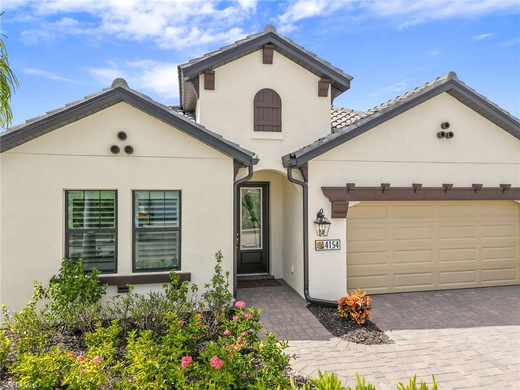 Welcome to this pristine,TURNKEY Tuscan-style home located in SKYSAIL, one of Naples' most desirable resort-style communities. Featuring 4 bedrooms, 3 full bathrooms, and approximately $125,000 in upgrades, this beautifully maintained residence is situated on a generously sized lot offering added privacy. Thoughtfully designed with elegant finishes and modern conveniences, this exceptional home offers the perfect combination of comfort, style, and effortless Florida living.

The light-filled, open-concept floor plan features beautiful 4-inch plantation shutters throughout, adding a touch of timeless elegance. The inviting great room flows seamlessly into the dining area and beautifully appointed kitchen, featuring white cabinetry, quartz countertops, a generous center island, natural gas range, and a walk-in pantry. Every detail has been thoughtfully considered for everyday living and entertaining. 

The primary suite offers a peaceful retreat with dual walk-in closets and ensuite bathroom featuring double vanities and a walk-in shower. A separate laundry room includes and upgraded washer and gas dryer, adding convenience to everyday living.

Step outside to the covered lanai, and ideal setting to relax, entertain, and enjoy breathtaking Southwest Florida sunsets.
A natural gas hookup for grilling adding outdoor entertaining, while the generous lot provides additional outdoor space and a wonderful sense of privacy.

Skysail is a gated community offering an exceptional collection of resort-style amenities, including a beautiful Lake House, resort-style pool, lap pool, fitness center, pickle ball and tennis courts, walking and biking paths, dog park, scenic lakes, and more-all with low HOA fees and NO FLOOD INSURANCE REQUIRED!

Conveniently located near shopping, dining, schools, Naples' beautiful white sandy beaches, and everything Southwest Florida has to offer.

Experience resort-style living at its finest in this pristine, TURNKEY Tuscan-style home in SKYSAIL! Truly a must see!