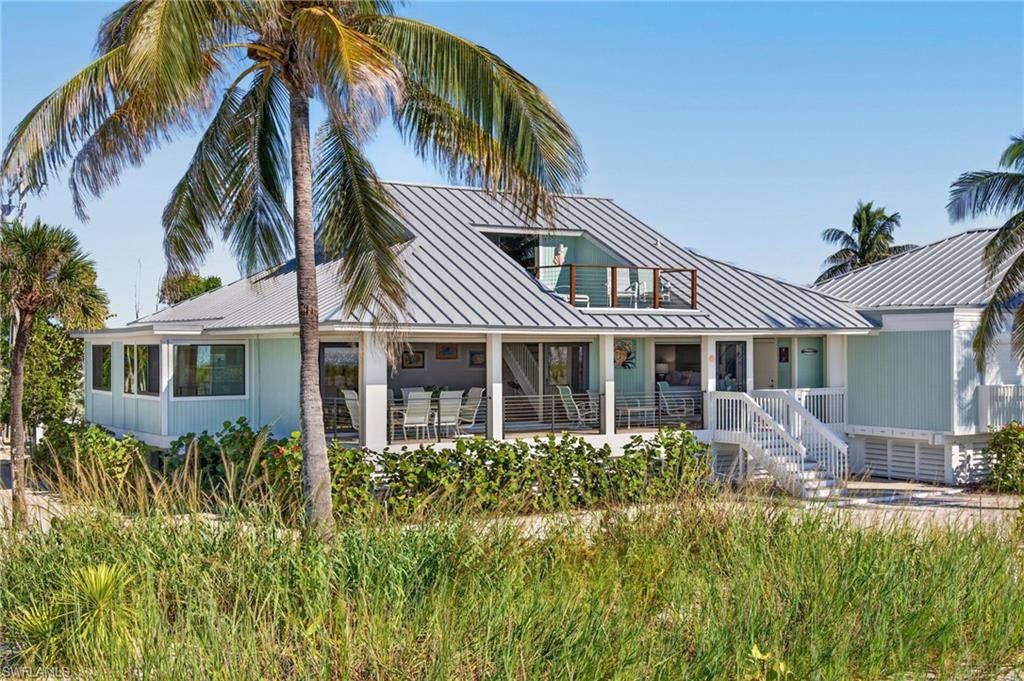 Just steps from the surf, this incredible Gulf front beach home has been designed to maximize views and perfectly blend indoor and outdoor living space. Pocketing sliders in the living room disappear from view so that from every angle aquamarine water and sand are the background for life at the beach. The north side of the home has no immediate neighbor, giving Beach House 11 a unique setting... no home obstructing views from the living room, kitchen and the window-lined sunroom that extends these spaces. Playful use of color gives the home a whimsical characteristic that is entirely fitting and welcoming for this beachfront Captiva home. The primary bedroom is on the first floor, with pocketing sliders as well. Fall asleep and wake up listening to the soothing sounds of waves upon the sand. Western exposure provides nightly sunsets, each more magical than the last. One guest bedroom on the first floor, two on the second. The sun porch on the second floor raises the bar for views... truly breathtaking! Newer mechanical storm shutters at the lanai, a tankless water heater, newer AC system and recently installed standing seam metal roof ensure ease of ownership. The Beach Home community has three pools, a tennis court, and is located within the South Seas resort which offers additional amenities to members.