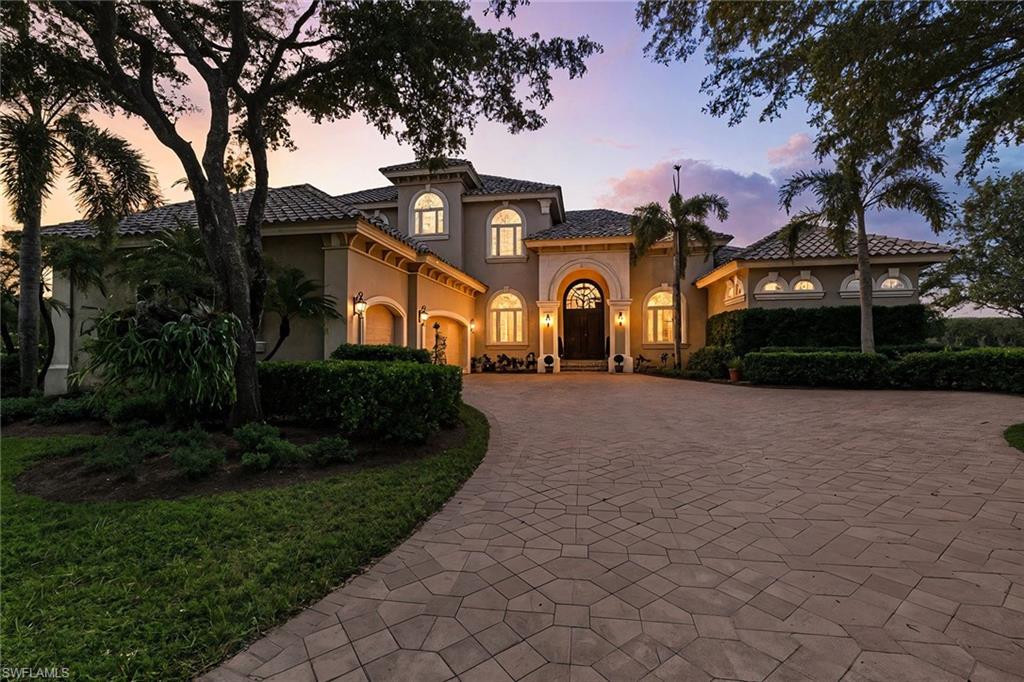 Prepare to be captivated by this extraordinary estate in Shadow Wood Preserve, where architectural design meets unmatched privacy and panoramic natural beauty. This residence reflects craftsmanship, intention, and quality rarely seen in today’s market. Perfectly positioned on a coveted south-facing, pie-shaped 0.6-acre lot, the residence highlights sweeping, panoramic 270-degree views of the lush, green golf course, preserve, and sparkling water views with no neighboring homes in sight. Step through the grand double doors where you’ll be greeted by soaring volume ceilings, elegant, coffered details, recessed lighting, and 10-foot disappearing sliders that dissolve the boundary between indoor comfort and outdoor splendor, both on the main and upper levels. Thoughtful upgrades throughout the property include a 2024 roof, 2023 Generac full home generator, 2023 new pool heater and pump/equipment, freshly upgraded and painted interior, three A/C units replaced since 2022, Lutron lighting system, a full house water filtration system, dual walk-in closets in the primary suite, walk-in closets in each bedroom and lush landscaping complemented by top-tier outdoor landscape lighting. Designed for effortless entertaining, the spacious gourmet kitchen features granite countertops, a wraparound bar, a center island, gas cooktop, warming drawer, wet bar with a wine cooler, and both a standard pantry and an expansive walk-in storage pantry. The adjoining family room, breakfast nook, living room, and primary suite include electric sunshades for enhanced comfort. An expansive upstairs creates a true second living level with a full bar, generous gathering game room space, three spacious bedrooms, two full baths, a music/hobby room, and a wraparound screened balcony offering commanding views. Outdoor living rivals a private resort with an expansive covered area, heated gas pool and spa, built-in outdoor kitchen and grill, 2023 screens, including a picture-window lanai screen for unobstructed views, a fenced side yard with a dog door, and a dedicated putting green on the opposite side of the property. Car enthusiasts will love the oversized three-car garage with extended dimensions allowing space for a golf cart behind each vehicle and capacity for up to six cars. With five bedrooms, three dens/offices, four full baths plus a pool half bath, abundant storage, and exceptional design throughout, this residence is a rare fusion of craftsmanship, privacy, and luxury living in one of Southwest Florida’s most intimate and nature-rich communities. HOA fees in Shadow Wood Preserve also cover fiber optic connection for internet, TV, and phone.