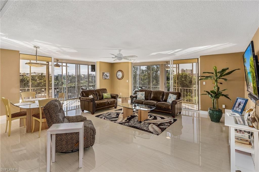 Corner condo with over 1,500 square feet.  Rare - Garage Parking Spot Included.  Buyer opportunity comes Turnkey Furnished.  HUGE, 22' X 20' living room with 60" TV.  HUGE L Shape wrap around lanai with newer screens and Gulf Views.  This 2 bedroom 2 bath has solid core doors in both bedrooms & bathrooms, new ceiling fans on lanai.  There is 5 1/2" Floor Base molding throughout.  Porcelain 32" X 16" tile floors thru out with the exception of the kitchen which has laminate floor.  Kitchen & baths have been updated with Master shower recently remodeled.  Steps from the beach.  Santini Plaza directly across the street that has boat marina, restaurants, shopping & entertainment a movie theater nearby.  Amenities include pool table, exercise room, swimming pool, tennis, shuffleboard, grilling area & sauna.  Located on the desirable south end of Ft Myers Beach, Lovers Key State Park is a short drive as well as Bonita Springs & Naples.  Who Do You Know That Wants to Buy a Beautiful Condo?