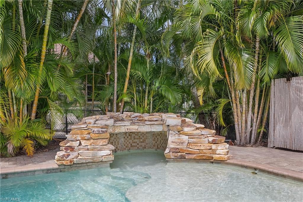 Rare triple waterfront property at the southern end of Pine Island on Emerald Ave! Situated on an oversized triple  180' x 110' lot with direct access to San Carlos Bay and the Gulf... this "turnkey" 3-bedroom, 2-bath ranch home offers an exceptional waterfront lifestyle. The updated home features a screened entry, tiled floor thru-out living room, updated kitchen, glass-enclosed Florida room with water views, split-bedroom floor plan, and primary suite with private bath. Off the kitchen, the cabana room provides convenient access to the resort-style pool area. The approximately 10' deep pool features a beach-style walk-in Baja shelf, a rock waterfall in the rock grotto, the Diving structure remains in place; diving board has been removed. Boaters will appreciate the large Captain's Dock with composite decking, two boat lifts (5,000-lb and 12,000-lb), boat ramp, and boathouse offering additional storage and workshop space. The canal provides quick access to open water, San Carlos Bay, and the Gulf. Tropical landscaping and the expansive triple lot provide plenty of outdoor space and privacy. A unique Pine Island waterfront property with extensive boating and outdoor amenities.