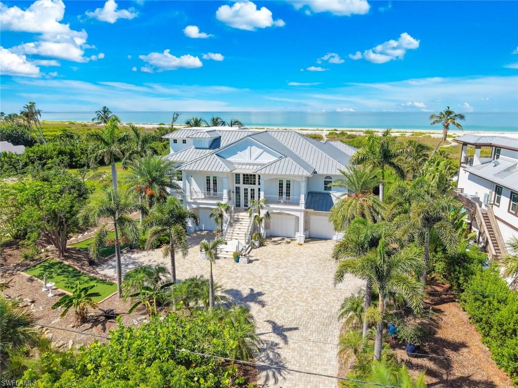 Stunning Gulf Views & Spectacular Sunsets in Château Sur Mer. Experience breathtaking Gulf vistas and unforgettable sunsets from this custom-built four-bedroom residence situated on over an acre in the coveted community of Château Sur Mer. Freshly painted inside and out, this home is beautifully refreshed and move-in ready. Expertly constructed and beautifully appointed throughout, it reflects exceptional craftsmanship and meticulous attention to detail. The primary suite crowns the top floor, offering sweeping 180° views of the beach, shoreline, and the azure waters of the Gulf. Its luxurious bath features an exquisite onyx and jade shower along with cloisonnésinks, creating a spa-like retreat. All guest bedrooms are generously sized, en suite, and finished with gorgeous maple flooring accented by walnut inlays. Designed for the discerning chef, the kitchen showcases custom cabinetry, fossil rock countertops, double ovens, a walk-in pantry, and a large center island. The expansive pool area is accented with charming sea life mosaics, while the surrounding decking provides a spacious covered lanai, ample sunbathing areas, and a generous spa, perfect for relaxation and entertaining. Tremendous storage on the ground level and an oversized elevator services all three floors. Château Sur Mer has long been admired for its large parcels, low density, and serene natural setting, making this property a rare offering in an exceptional coastal community.