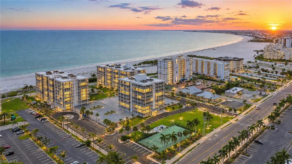 Welcome to the Creciente lifestyle — where the beach, the Gulf and spectacular sunsets are part of everyday life.
This exceptional beachfront residence which rarely comes on the market offers an incredible 180-degree view of the beach and Gulf of Mexico, highlighted by a rare 75-foot wrap-around lanai. Both bedrooms open directly onto the lanai, allowing you to wake up to beautiful Gulf views and enjoy Florida's indoor-outdoor lifestyle throughout the day.
Hurricane-rated sliding glass doors along the exterior of the lanai allow this wonderful space to be enjoyed in all types of weather, while exterior solar shades provide additional comfort and privacy. Whether enjoying your morning coffee, entertaining friends or watching another magnificent Southwest Florida sunset, this lanai is truly an extension of the living space. 
Inside, the kitchen and bathrooms feature custom maple cabinetry with Corian countertops. Thoughtful details include base cabinets with pull-out shelving, a pantry with pull-out shelves and an appliance garage. A Culligan reverse-osmosis system provides filtered drinking water and water for the ice maker.
The guest bedroom features a 7-foot workstation, ideal for a home office, hobbies or projects. Additional features include ceiling fans, window valances and a Jacuzzi whirlpool tub in the primary bath. A coveted covered garage parking space is also included.

The Creciente Lifestyle
Life at Creciente revolves around the beach and one of the most impressive pools on Fort Myers Beach. Spend the afternoon at the water's edge, relax poolside or meet neighbors and friends at frequent association parties and informal gatherings.
The beautifully restored community offers an impressive collection of amenities, including a new fitness center, saunas and game rooms, tennis and pickleball courts, bocce and cornhole, and fully restored tropical landscaping.

Pets are welcome, and state-of-the-art security provides controlled access to the building lobbies. The property is professionally managed, making ownership convenient whether this is your full-time residence, seasonal retreat or investment property.
And the location is hard to beat! Simply cross the street to Santini Marina Plaza for shopping, restaurants and entertainment — no need to get in the car.
With its extraordinary wrap-around lanai, panoramic Gulf views, garage parking and beachfront location, this is a wonderful opportunity to enjoy everything that makes Creciente and Fort Myers Beach so special.
Beach. Pool. Sunsets. Friends. And the Gulf right outside your door.