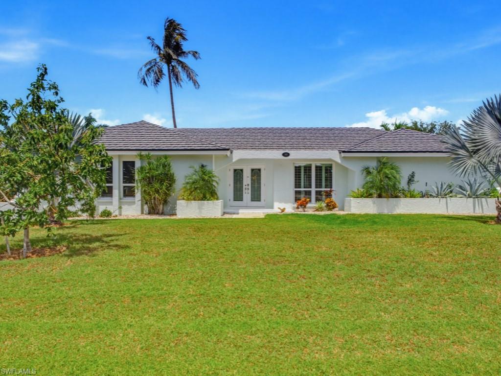 Set on an expansive homesite that is almost 1/2 acre, this residence presents a rare opportunity to enjoy generous space, privacy, and the distinctive island setting of one of Marco’s most desirable neighborhoods. Positioned on a quiet cul-de-sac and surrounded by impressive residences, this three-bedroom, two-bath home offers more than 2,300 square feet of living space with a thoughtfully designed split-bedroom floor plan. The home features spacious living and dining areas, a comfortable family room, and an easy connection to the screened lanai and private pool, creating an exceptional outdoor space with mature tropical surroundings and room to enjoy, entertain or envision future possibilities. Additional features include an attached two-car garage, interior laundry room, generous primary suite with walk-in closet, and ample storage throughout. Recent improvements include replacement impact windows and front door, a whole-house generator, plus a new AC in 2025. Ideally situated within Marco Island’s sought-after Estate section, the home is just minutes from the island’s renowned beaches, boating, dining and shopping. Whether enjoyed as it stands, thoughtfully reimagined or considered for its exceptional homesite, this property offers an excellent opportunity to create a distinctive Marco Island residence.