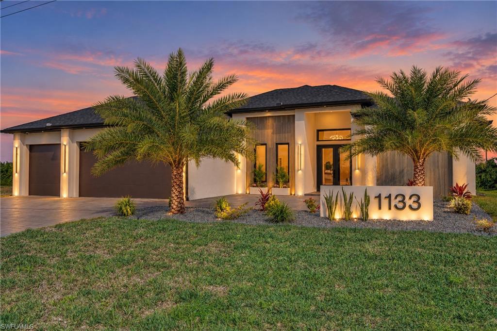 Welcome to Your Dream Home on the Water! Step into luxury with this brand-new construction masterpiece, designed to elevate modern living. Featuring 4 spacious bedrooms, 3 beautifully appointed bathrooms, and a generous 3-car garage, this home blends style, comfort, and functionality. Nestled along a freshwater canal, it offers beautiful water views, a private deck, and premium upgrades that make every day feel like a resort getaway.

From the moment you enter, soaring ceilings and a bright, open floor plan seamlessly connect the living, dining, and kitchen areas—perfect for entertaining or enjoying the Florida lifestyle. Large impact windows and glass sliders welcome natural light and frame the canal views. The gourmet kitchen features sleek cabinetry, top-of-the-line appliances, and elegant finishes.

Just steps away, the outdoor summer kitchen includes a built-in stove, sink, and mini fridge beneath a covered lanai—ideal for outdoor dining and entertaining. The saltwater pool and spa take center stage, fully screened within a panoramic enclosure that enhances the waterfront setting. Whether you’re swimming, soaking, or sunbathing, the backyard is your private retreat.

Each bedroom offers comfort and privacy, with custom-built closets that maximize storage and organization. The primary suite features serene water views, a spa-like ensuite bathroom, and beautifully designed walk-in closets. The three-car garage provides ample space for vehicles, recreational gear, and storage.

Located in a peaceful neighborhood, this move-in-ready waterfront home offers the perfect setting to enjoy the best of Florida living.