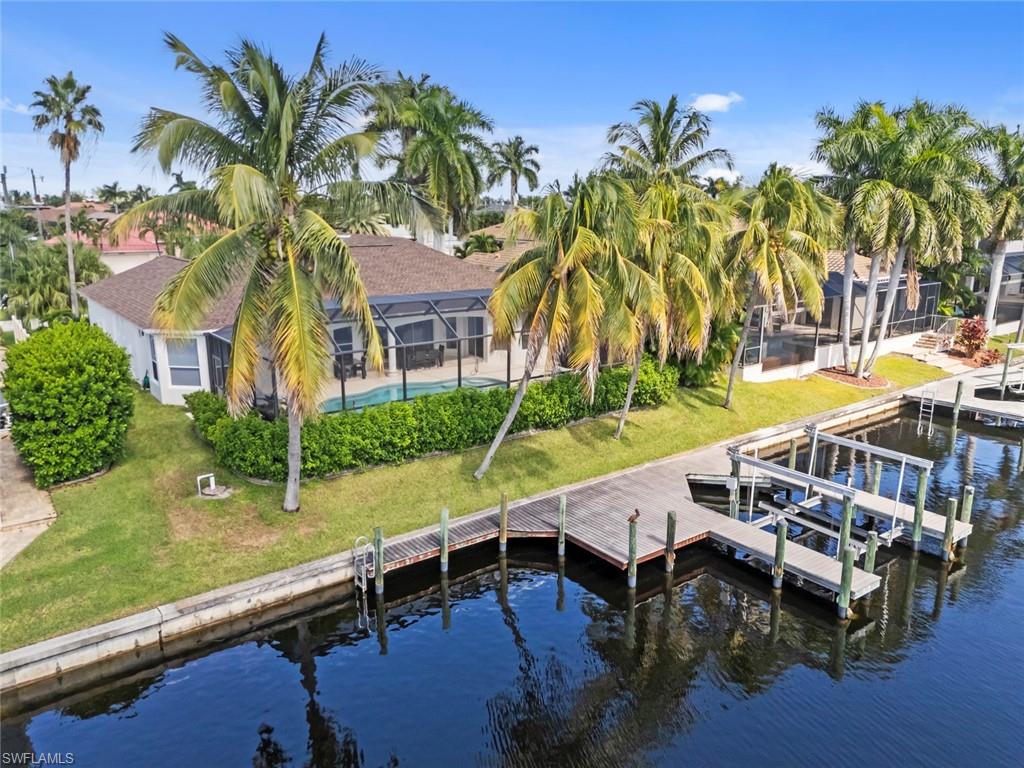 BOATER'S PARADISE! GULF ACCESS, PRIVATE BOAT DOCK WITH BOAT LIFT, SOUTHERN EXPOSURE, BRAND-NEW ROOF (OCTOBER 2026), FRESH EXTERIOR PAINT, AND OFFERED TURNKEY! Welcome to your own piece of Southwest Florida paradise, perfectly situated in one of Cape Coral's most desirable waterfront locations, just minutes from Cape Harbour Marina, waterfront dining, shopping, and entertainment. Whether you're searching for a winter retreat, a vacation getaway, or a place to enjoy the Florida lifestyle year-round, this beautifully maintained 3-bedroom, 2-bath Gulf-access pool home is ready for you to move right in and start enjoying!

Step inside to a bright and welcoming living space designed for comfortable everyday living and effortless entertaining. The thoughtfully designed floor plan offers spacious living and dining areas, a well-appointed kitchen, and inviting bedrooms, providing plenty of room for family and visiting guests. Best of all, the home comes TURNKEY, making your transition to paradise as easy as bringing your suitcase!

Outside is where the true Florida lifestyle begins! The desirable SOUTHERN EXPOSURE fills your outdoor living area with sunshine throughout the day, while the screened lanai and solar-heated pool invite you to relax, entertain, and enjoy the beautiful Southwest Florida weather. Boating enthusiasts will love the private dock with its own boat lift, providing convenient access to Cape Coral's extensive canal system and the Gulf of Mexico. Imagine spending your mornings out on the water, exploring nearby islands and waterfront destinations, then returning home for a refreshing swim or a relaxing evening by the pool overlooking the canal.

For added peace of mind, the property features a BRAND-NEW ROOF installed in October 2026 and a freshly painted exterior, offering valuable recent improvements. Located in the highly sought-after Southwest Cape Coral area, you're just a short distance from Cape Harbour's vibrant waterfront atmosphere, restaurants, boutiques, and marina amenities.

Gulf access, your own boat dock and lift, southern exposure, a private pool, a fantastic location, and turnkey convenience. This home checks all the boxes for your Southwest Florida waterfront escape! Schedule your private showing today and start living the boating lifestyle you've been dreaming of!