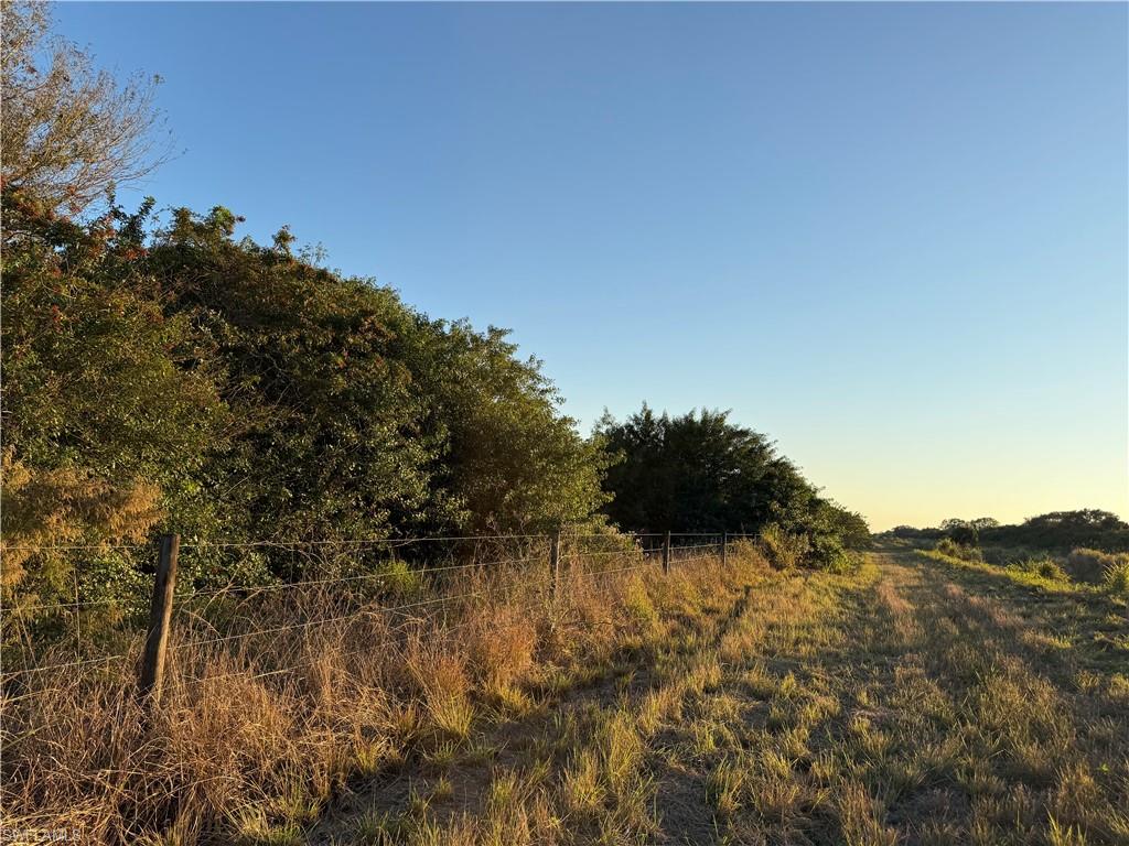 49.46 +/- acres partially cleared with beautiful oak trees and palmettos throughout, ideal for someone looking for a peaceful setting to build a farm, ranch, or weekend escape. This property is located at the southwest corner of 4th Rd and bordered by canals on two sides, offering extra privacy and seclusion. This property is zoned Ag-2, which allows for residential use. The canal at the south end of the property is available for irrigation and serves as a natural border. Besides citrus, there are many small farms in the area growing row crops and tropical fruit (lychee, mango, dragon fruit, passion fruit, etc.). Approximately 1 hour from RSW, and 45 minutes from I-75  via SR 29 in Immokalee or SR 80 in Fort Myers. Property is in the Gerber Water District and subject to the Water District tax which is collected by the Hendry County Tax Collector and is used to maintain the roads, canals, and employ security. The roads are private and monitored by a security guard to prevent trespassing.