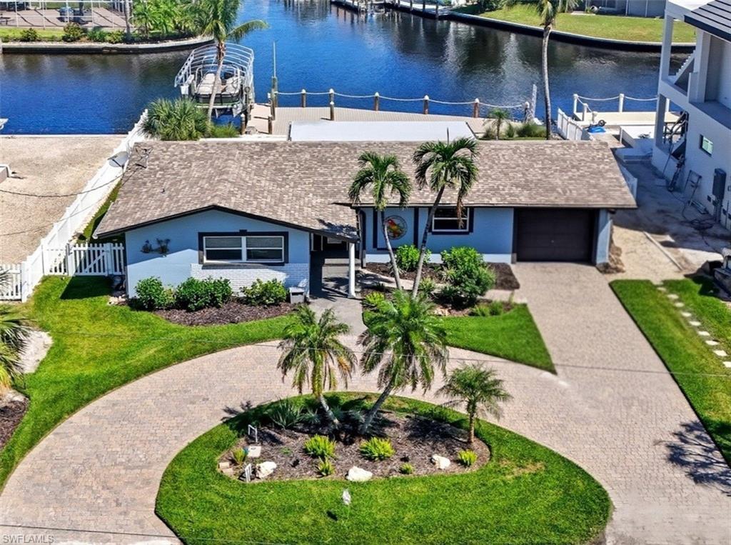 Panoramic Waterfront Views from this Amazing Pool home with Oversized Dock. Embrace the ultimate Florida lifestyle in this charming 2-bedroom, 2-bathroom single-family home, perfectly positioned on an 75 ft extra-wide lot with intersecting canals. Enjoy endless opportunities for outdoor recreation, whether it's fishing, boating, kayaking, or simply soaking in the sights and sounds of local wildlife from your own backyard. For boating enthusiasts, a 10,000 lb boat lift is already in place, ready to launch you into all your water adventures. With direct access to the canals, you'll have the convenience of enjoying the waterfront year-round. Located in the highly sought-after Fairview Isles community, this home is just minutes from Fort Myers Beach's south end, Bonita Springs, and Naples. The Fort Myers International Airport is also a short drive away, making travel a breeze. Dining, shopping, and entertainment are just around the corner at the Santini Marina Plaza, and with deeded beach access, you’ll have the freedom to stroll along the shoreline at your leisure. Whether you're seeking a peaceful retreat or a base for your coastal explorations, this property offers the perfect blend of comfort and potential to fully embrace the waterfront lifestyle.Don’t miss your chance to own this incredible piece of paradise!