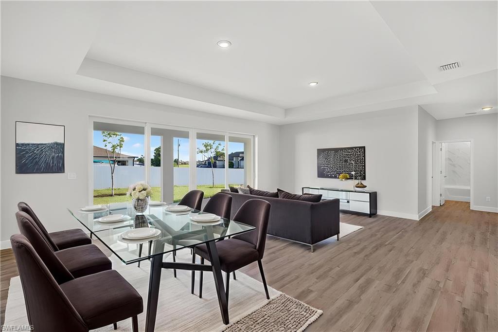Corner Lot | Dual Primary Suites | 3 Bathrooms | 3-Car Garage | HUGE Walk-In Pantry | No Flood Zone

Move-in ready home offering 4 bedrooms, 3 bathrooms, and a highly sought-after dual-primary-suite layout—perfect for multigenerational living, visiting guests, or a private home office retreat.
Modern design meets everyday comfort. This open-concept floor plan features soaring tray ceilings, a spacious great room, and seamless indoor-outdoor living with a massive covered back patio and plenty of room to add a pool.
The chef-inspired kitchen showcases quartz countertops, soft-close, all-wood cabinetry, stainless steel appliances, and a large center island with breakfast-bar seating that flows seamlessly into the living room—perfect for entertaining! A huge walk-in pantry provides exceptional storage.
The split-bedroom floor plan offers a spacious owner's suite with sliding doors leading to the lanai, dual sinks, a large walk-in closet, and a beautifully appointed glass-enclosed shower. A second private suite features its own full bathroom, walk-in closet, and a pool-bath door leading directly to the lanai, providing exceptional flexibility and privacy for guests or family members. The home also features LVP flooring throughout, including all bedrooms—no carpet!
Conveniently located near shopping, dining, entertainment, and major roadways, with easy access to I-75 and Southwest Florida's beautiful beaches.
Builder-backed by a 1-year workmanship warranty and a 10-year structural warranty for added peace of mind.
Some photos may be virtually staged. This home features the Bluewater Cove floor plan.