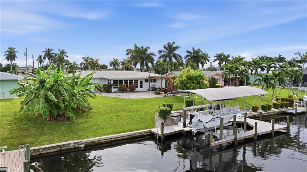 Welcome to waterfront living in highly desirable Southeast Cape Coral! This beautifully maintained 3-bedroom, 2-bath Gulf-access home has been incredibly well cared for and offers the perfect combination of comfort, location, and boating convenience. High and dry with no flooding from recent hurricanes, this home offers added peace of mind along with several major updates, including a newer 2023 roof, new impact windows, and newer A/C.

Boaters will love the brand-new beautiful dock featuring a 20,000-lb covered boat lift (accommodates up to 32' long by 12' wide boat), making it easy to enjoy everything Southwest Florida waterfront living has to offer. Relax along the canal, hop on the boat, or simply enjoy the peaceful water views right from your own backyard.

Inside, the home offers a comfortable, inviting layout with three bedrooms, two bathrooms, and a Florida room providing additional space to relax or entertain. Conveniently located in Southeast Cape Coral, you’re close to shopping, dining, entertainment, and everything this sought-after area has to offer.

Whether you’re looking for a full-time residence, seasonal getaway, or your own waterfront retreat, this move-in-ready home is one you won’t want to miss!