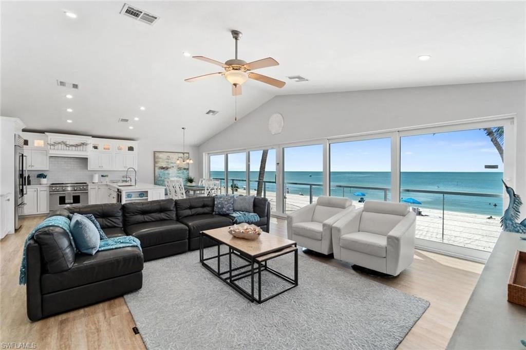 Looking to own a beach front home that will pay all expenses plus profit and still let you enjoy the weeks you desire - you have found it. Investors - home is booked nearly year round with 5 star reviews and is kept in immaculate condition. “Copacabana on Bonita Beach” is sold turnkey furnished in contemporary coastal style and there are bookings in place with rental history for review. This 2 story Bonita Beach Gulf front home offers 3,230 total living sq ft and 1,725 AC sq ft with 3 bedrooms & 2.5 baths ideally located in the southern most part of the island. This beautifully renovated DIRECT BEACHFRONT home is finished iwith a light, bright, coastal contemporary design and as you reach the top of the stairs all you see, feel and hear is the surf of the turquoise waters and white sand beach of the Gulf. The open floor plan provides simple easy beach living and includes: house-wide pocketing sliding glass doors, cable wire railing for unobstructed views, all hurricane impact glass/sliders, vaulted ceilings, solid interior doors & designer plumbing and light fixtures. The kitchen features quartz counters with subway tile backsplash, white custom cabinetry to the ceiling with modern chrome fixtures & soft-close drawers, stainless-steel farmer’s sink with chef’s faucet, Subzero glass door refrigerator, Wolf 48” gas range with high output hood above & built-in Sharp microwave. Baths have quartz counters, white cabinetry/vanities, frameless showers with mosaic & subway tiles and Kohler one-touch commodes. The large great room and dining room also sit right over the water. The master bedroom includes a master bath with modern specialty sink with dual faucets & multiple shower heads in the large shower. Guest bedroom two offers two sets of built-in bunk beds allowing sleeping for 4. Guest bedroom three, guest bath and laundry complete the one level living. The lower level includes a 2-car garage, storage and beachfront entertainment area with plenty of room for a Gulf-front pool. Walk to restaurants, jet ski rentals, boat rentals, para-sailing. Mercato, Promenade, Coconut Point, entertainment, golf courses and the International Airport are all nearby. Note: The property next door to the north is also being sold by Seller with same great rental history and current bookings in case you are looking for a larger rental property investment MLS 226034608.